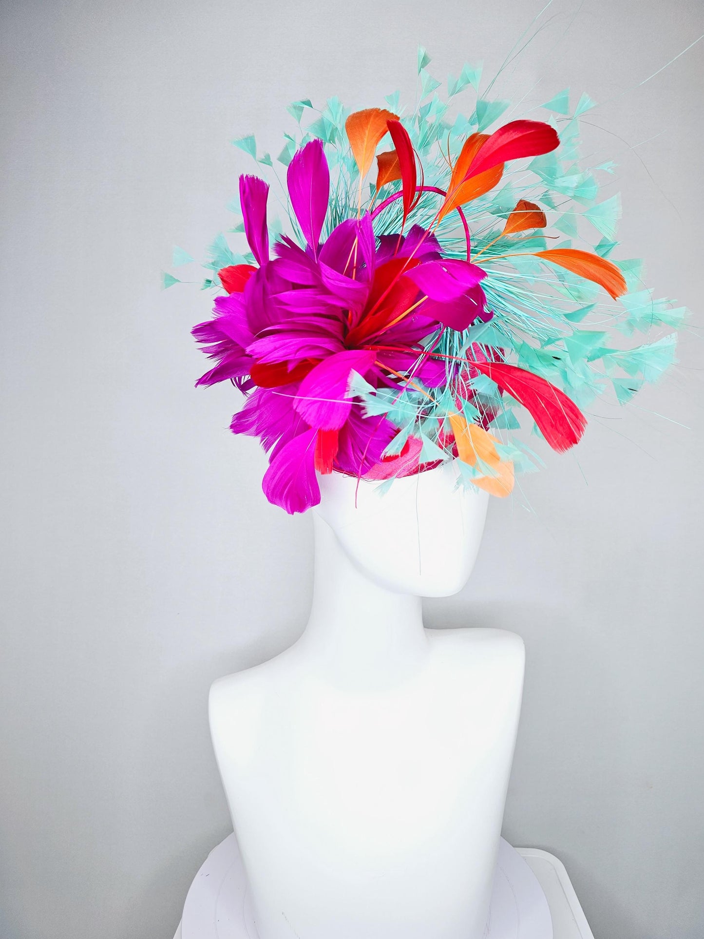 kentucky derby hat fascinator pink satin with netting and fluffy bright pink fuchsia, aqua blue green, red, orange coral branching feathers