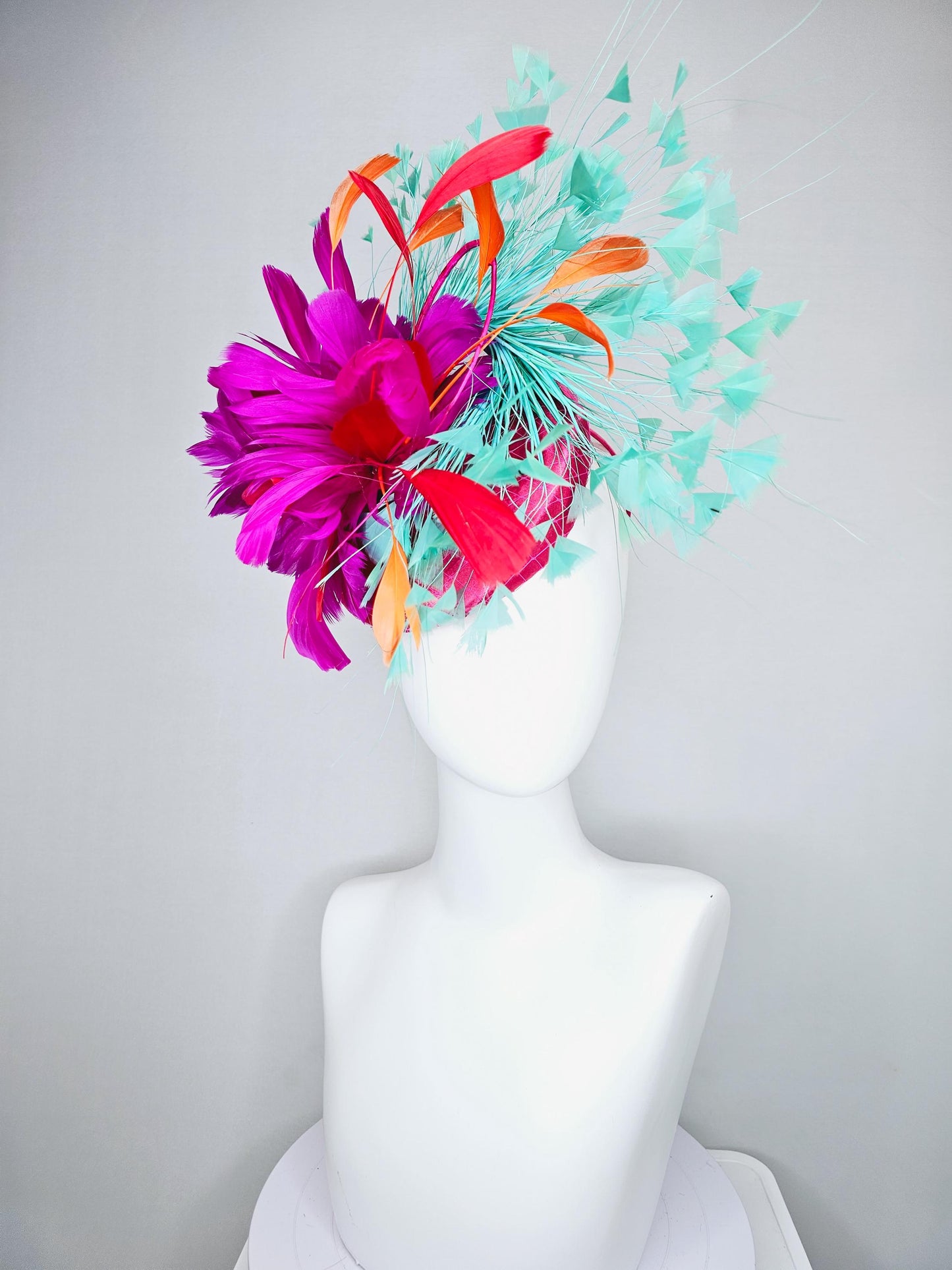 kentucky derby hat fascinator pink satin with netting and fluffy bright pink fuchsia, aqua blue green, red, orange coral branching feathers