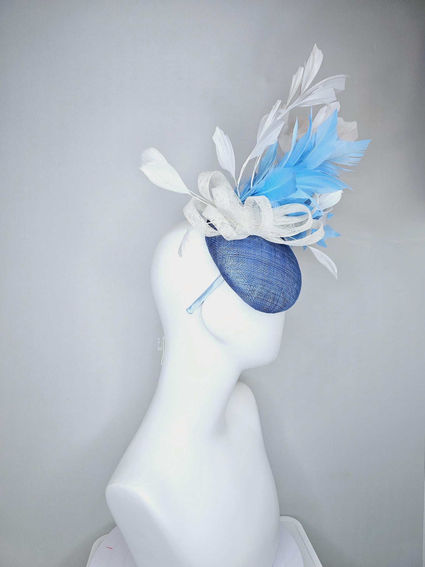 kentucky derby hat fascinator dark blue sinamay base with white sinamay bow, sky blue and white branching feathers