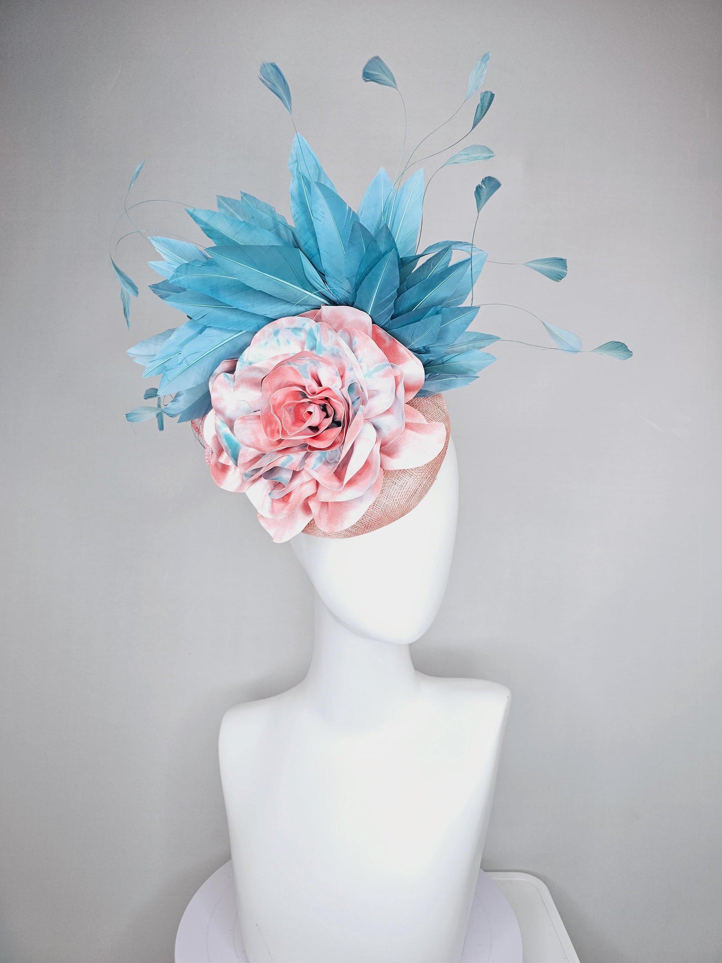 kentucky derby hat fascinator light baby pink sinamay with bright blue branching feathers and large pink and blue tie dye rose flower