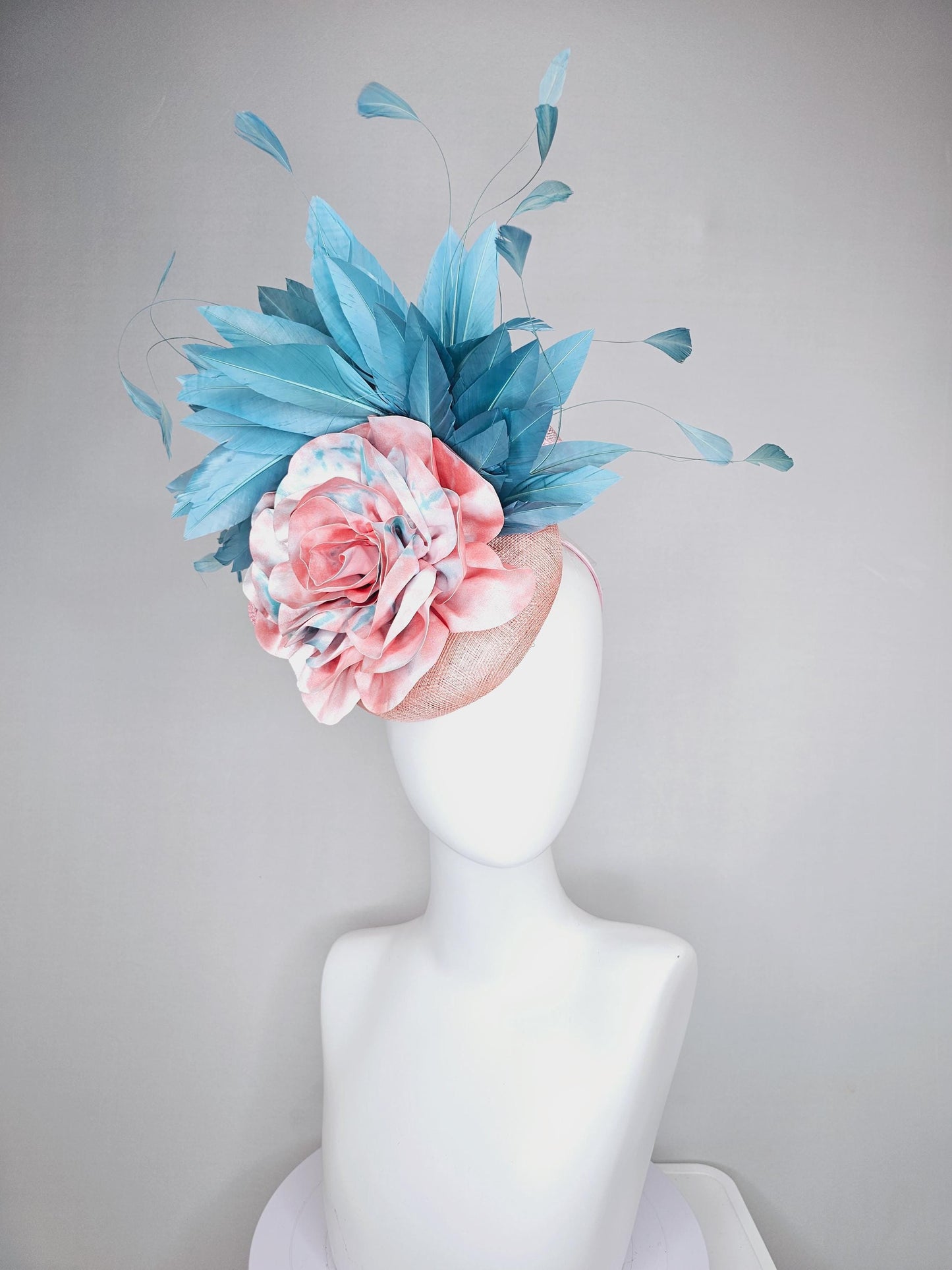 kentucky derby hat fascinator light baby pink sinamay with bright blue branching feathers and large pink and blue tie dye rose flower
