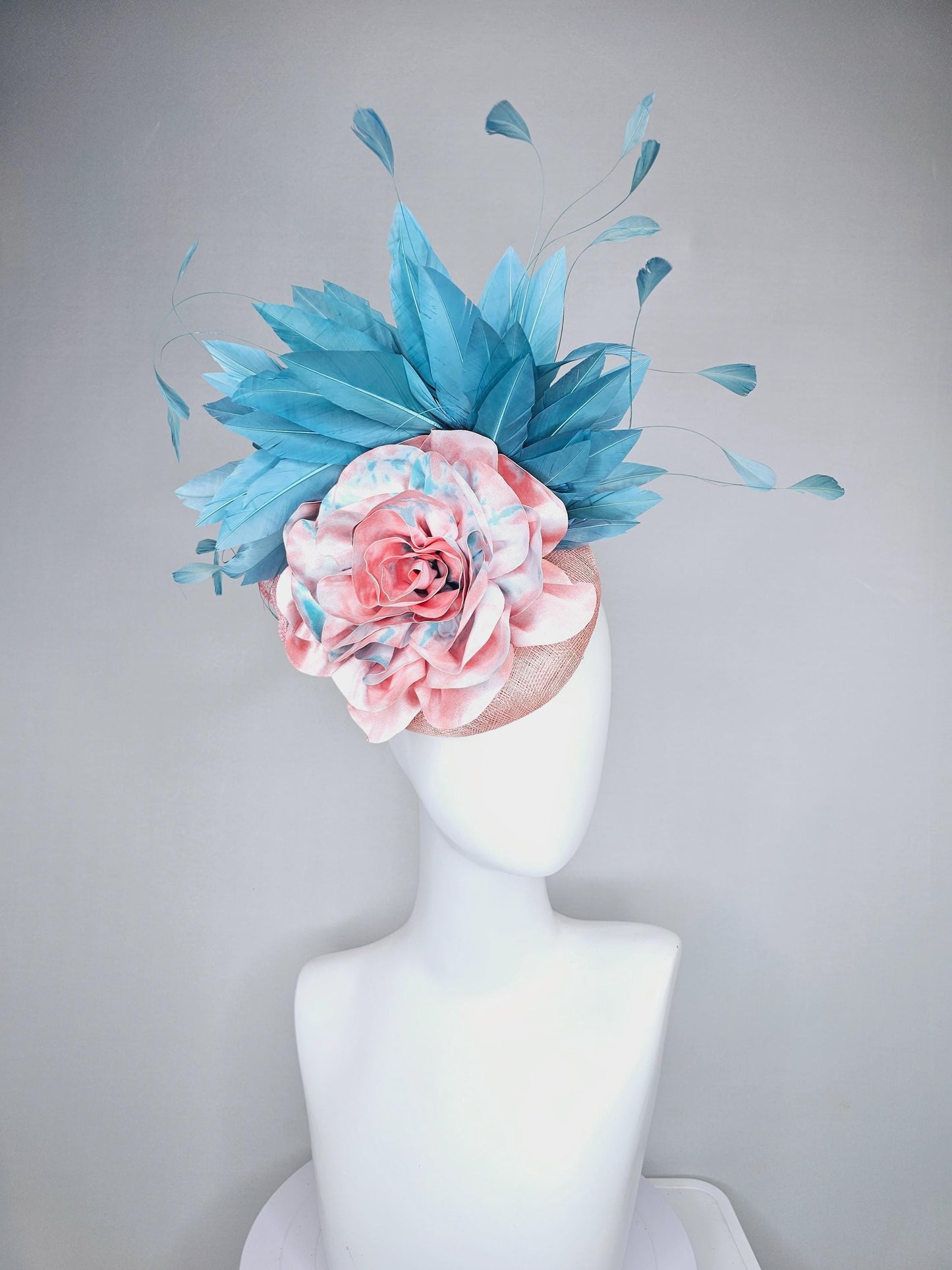 kentucky derby hat fascinator light baby pink sinamay with bright blue branching feathers and large pink and blue tie dye rose flower