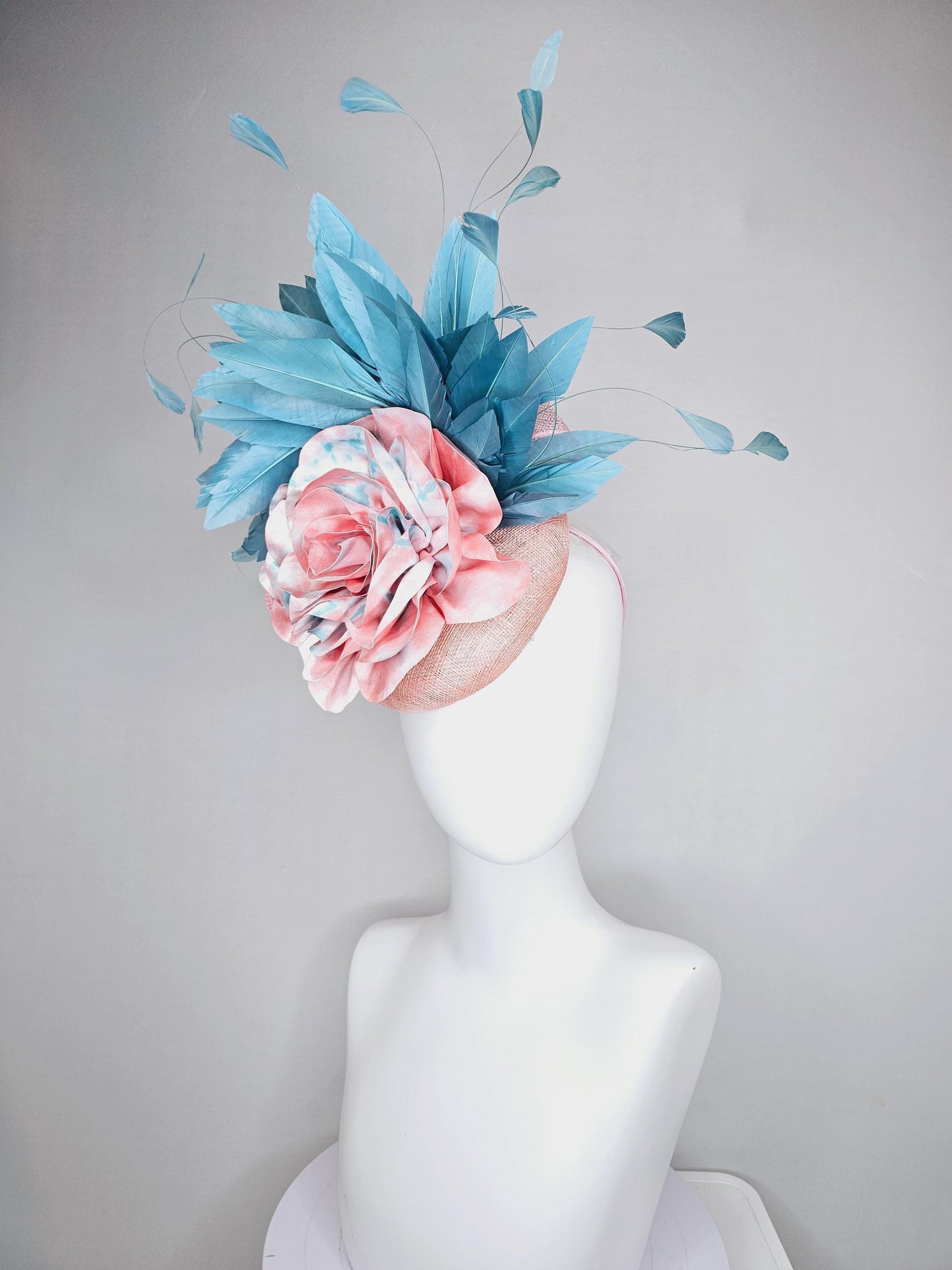 kentucky derby hat fascinator light baby pink sinamay with bright blue branching feathers and large pink and blue tie dye rose flower