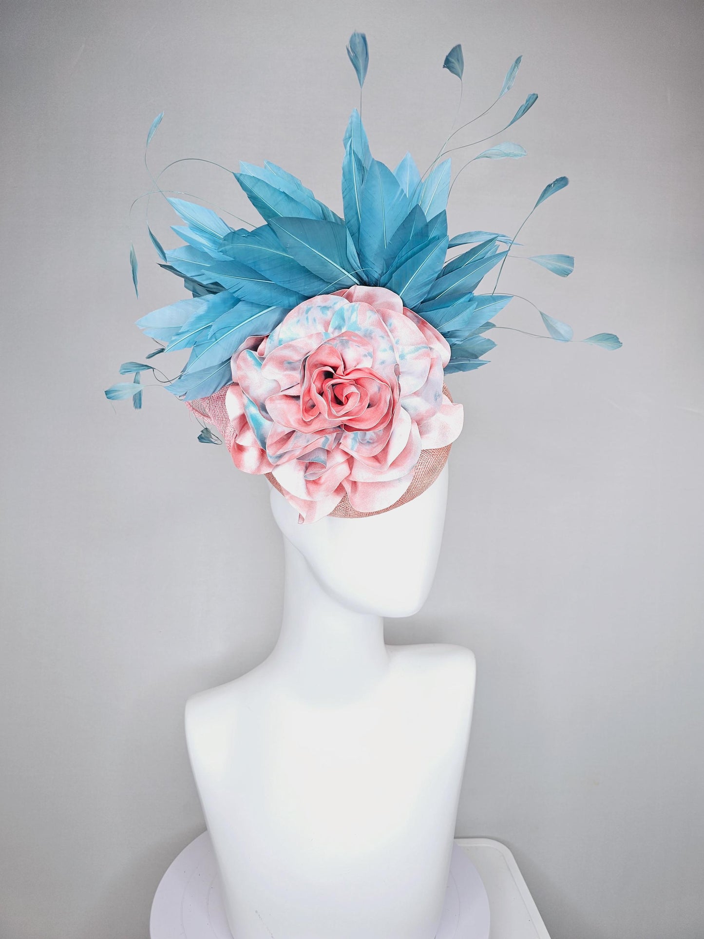 kentucky derby hat fascinator light baby pink sinamay with bright blue branching feathers and large pink and blue tie dye rose flower