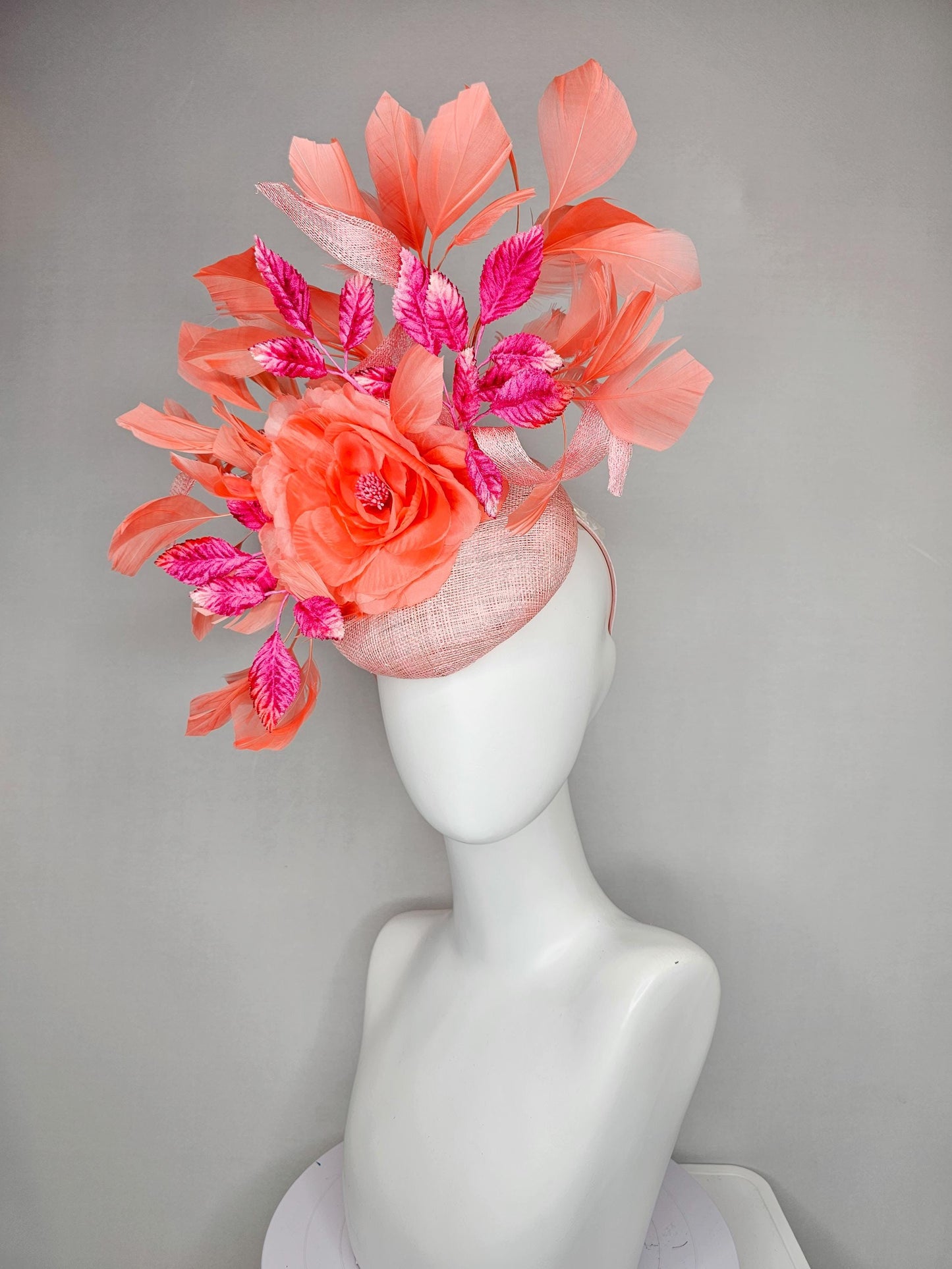kentucky derby hat fascinator light pink sinamay w/ coral orange peach satin rose flower, bright pink leaves,coral orange branching feathers