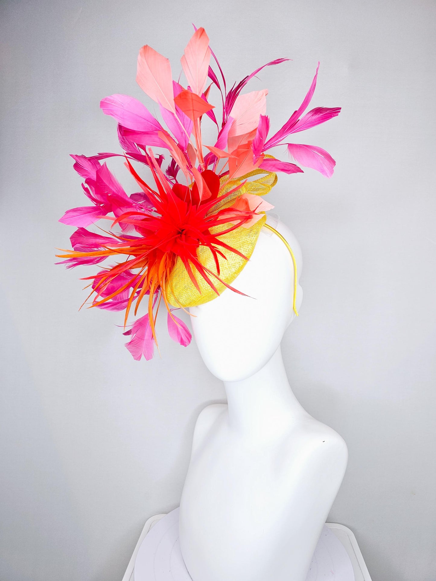kentucky derby hat fascinator yellow sinamay and curls with bright red feather flower with branching orange, coral, peach and pink feathers