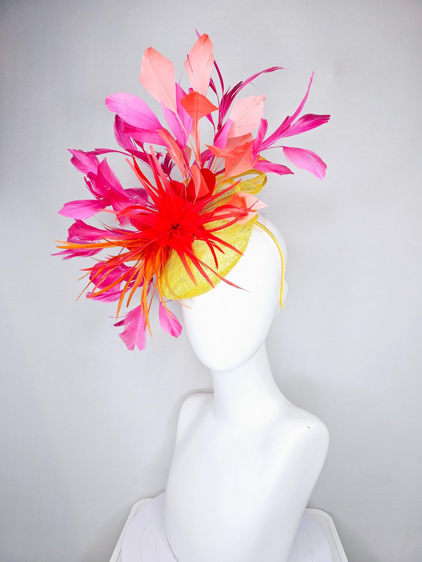 kentucky derby hat fascinator yellow sinamay and curls with bright red feather flower with branching orange, coral, peach and pink feathers