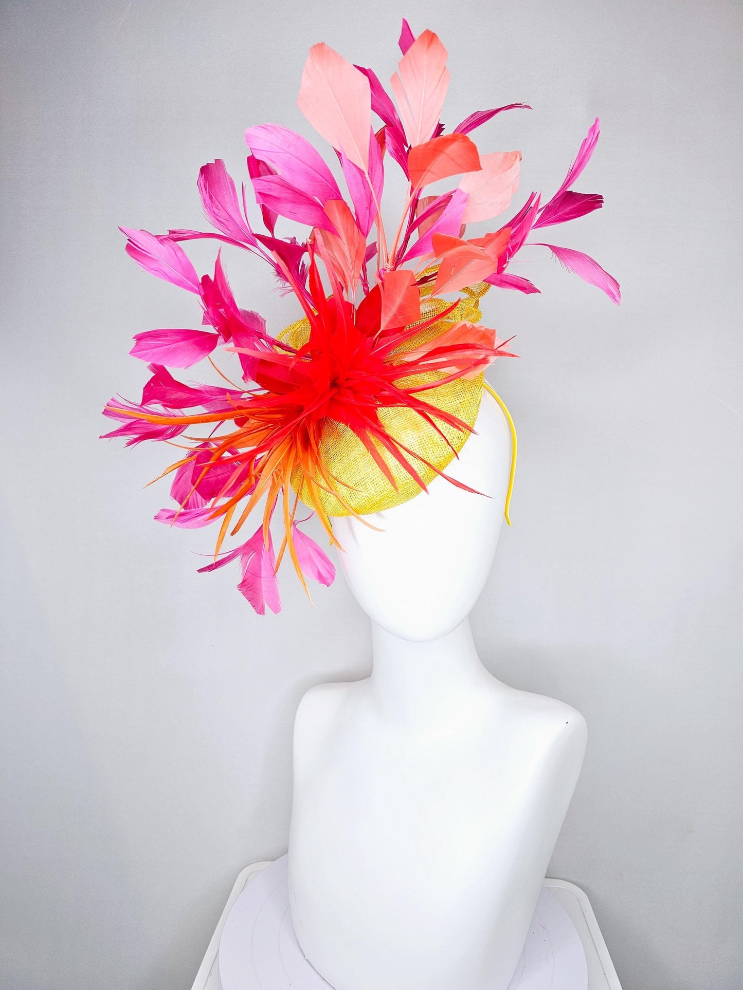 kentucky derby hat fascinator yellow sinamay and curls with bright red feather flower with branching orange, coral, peach and pink feathers