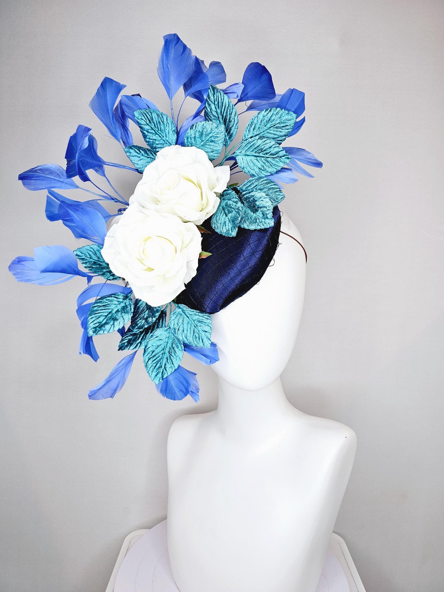 kentucky derby hat fascinator midnight navy blue satin with white silk flowers teal blue velvet leaves and royal blue branching feathers