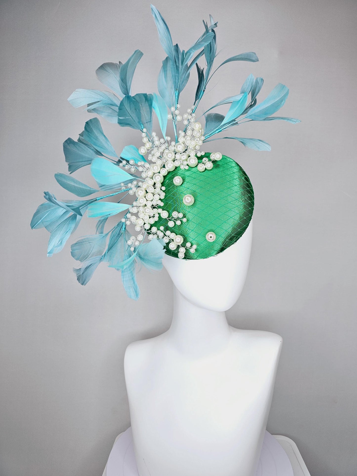 kentucky derby hat fascinator emerald green satin with netting and pearl beaded stems, teal blue branching feathers