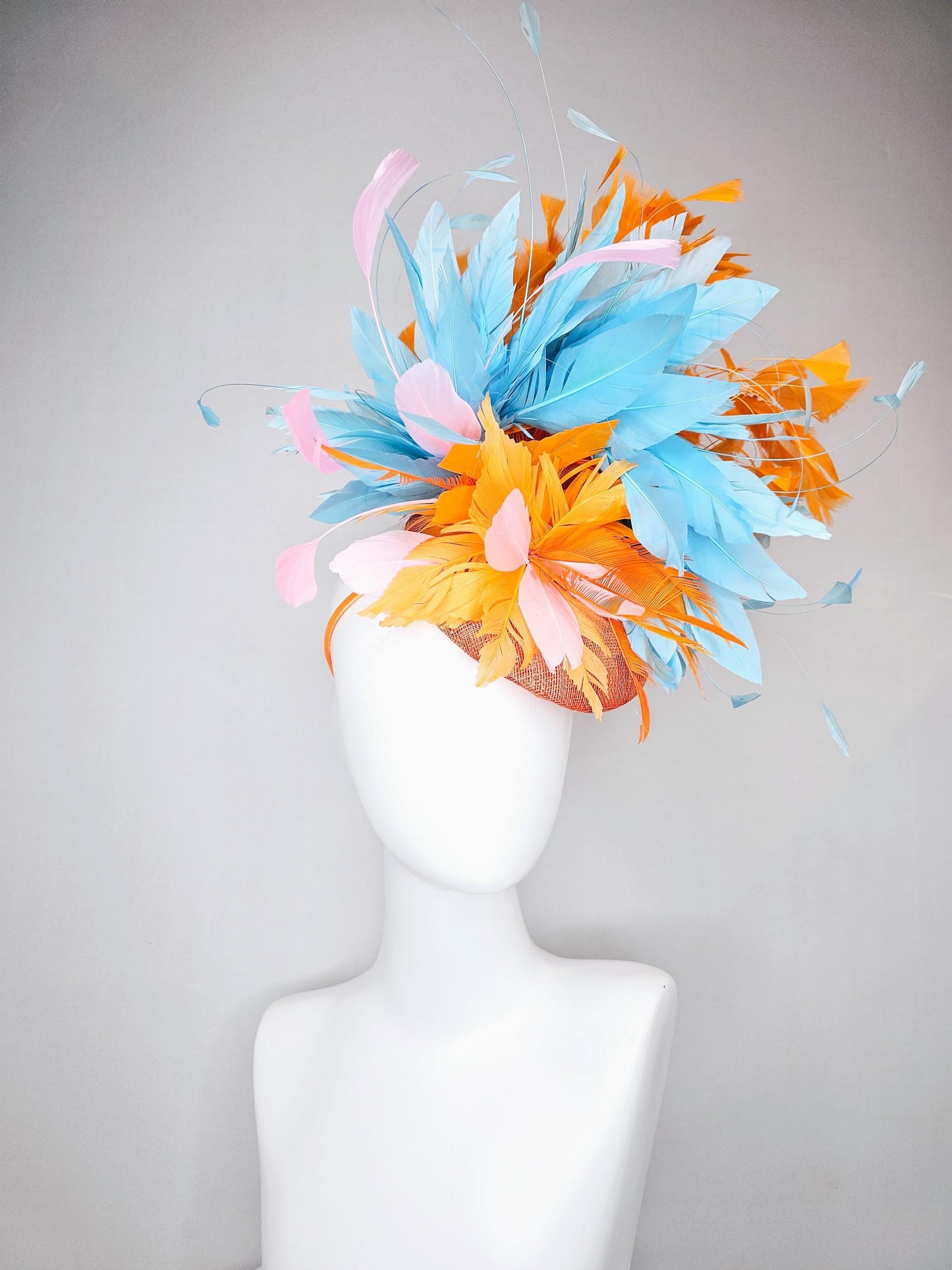kentucky derby hat fascinator orange sinamay with bright orange, sky blue and light pink branching feathers