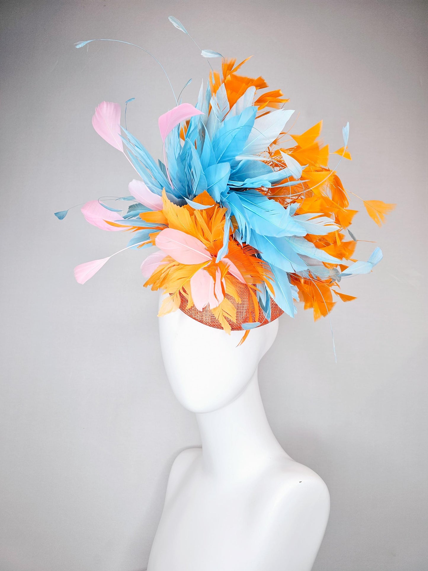 kentucky derby hat fascinator orange sinamay with bright orange, sky blue and light pink branching feathers