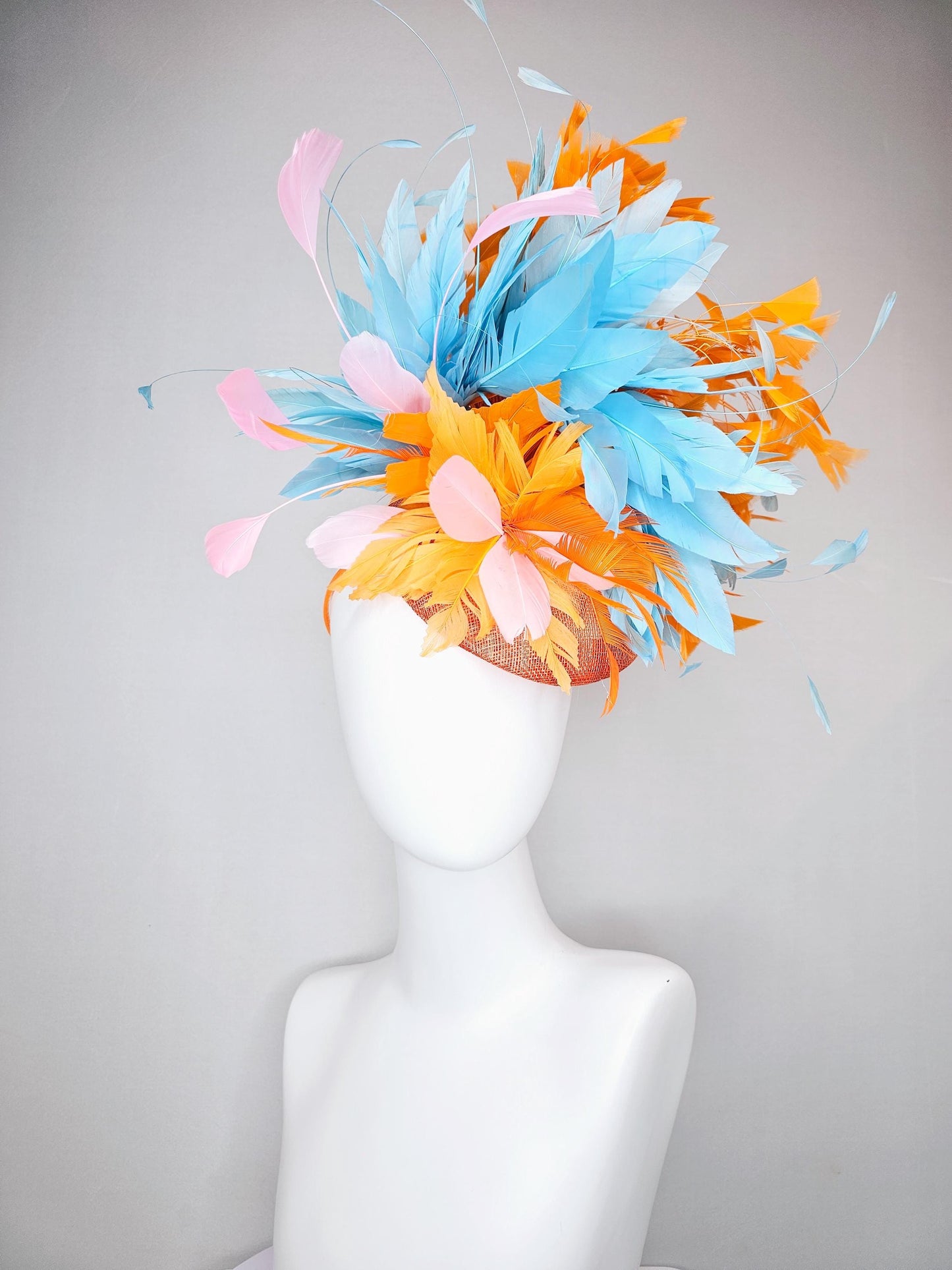 kentucky derby hat fascinator orange sinamay with bright orange, sky blue and light pink branching feathers