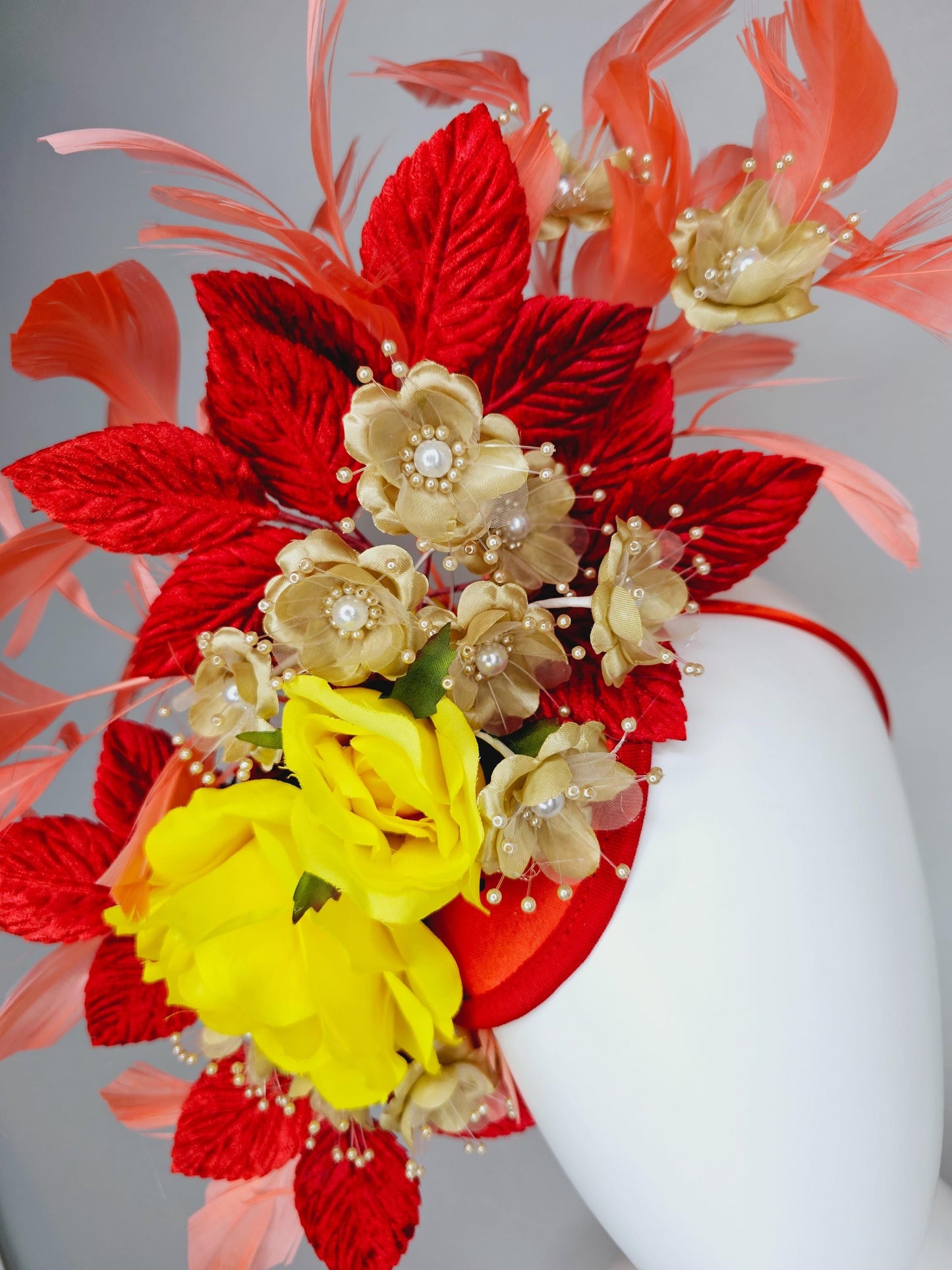 kentucky derby hat fascinator yellow satin roses,gold tan beige satin flowers with pearls,scarlet red leaves,coral orange branching feathers