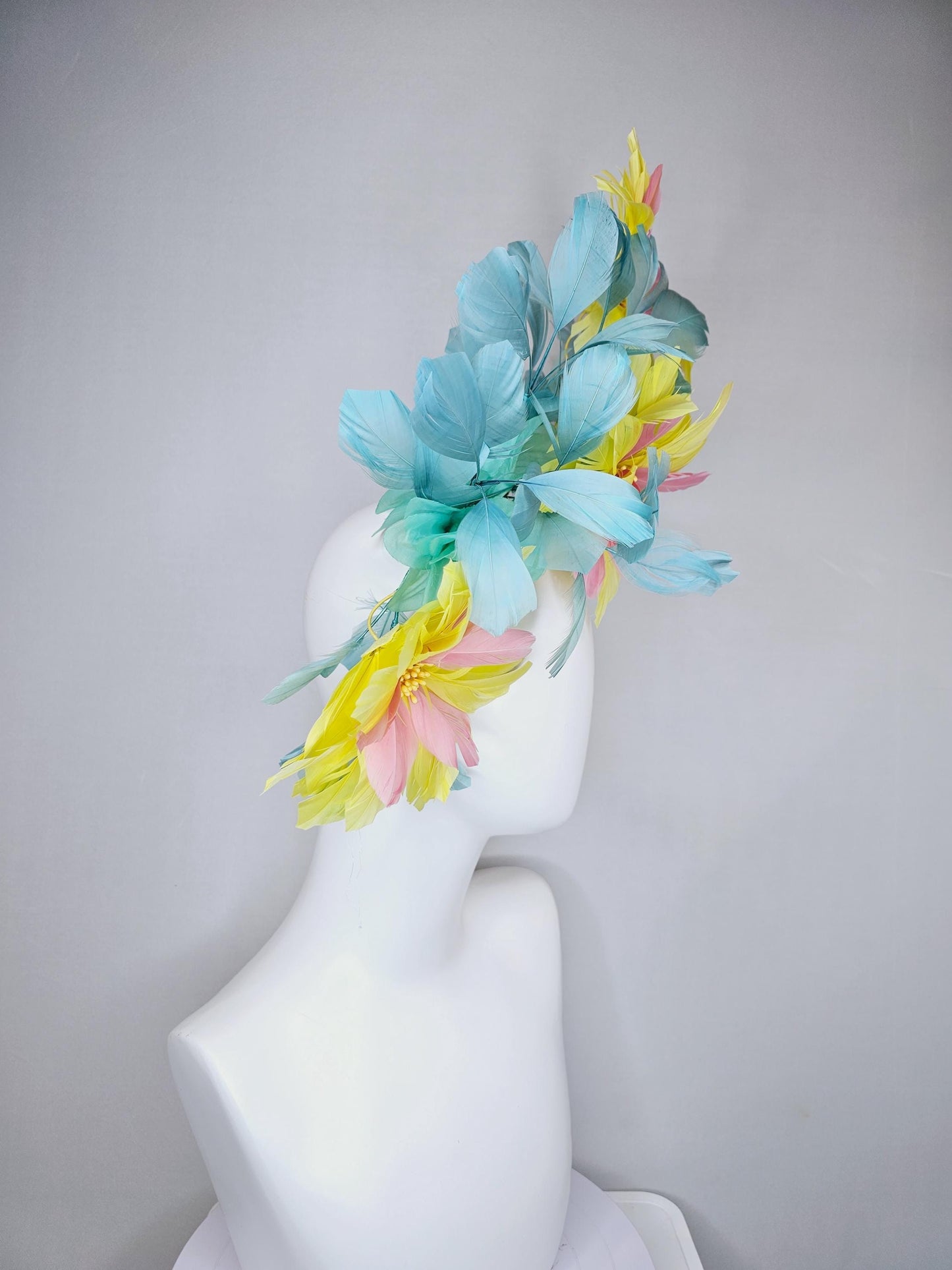 kentucky derby hat fascinator with large yellow light blush pink feather flowers and light teal blue branching feathers