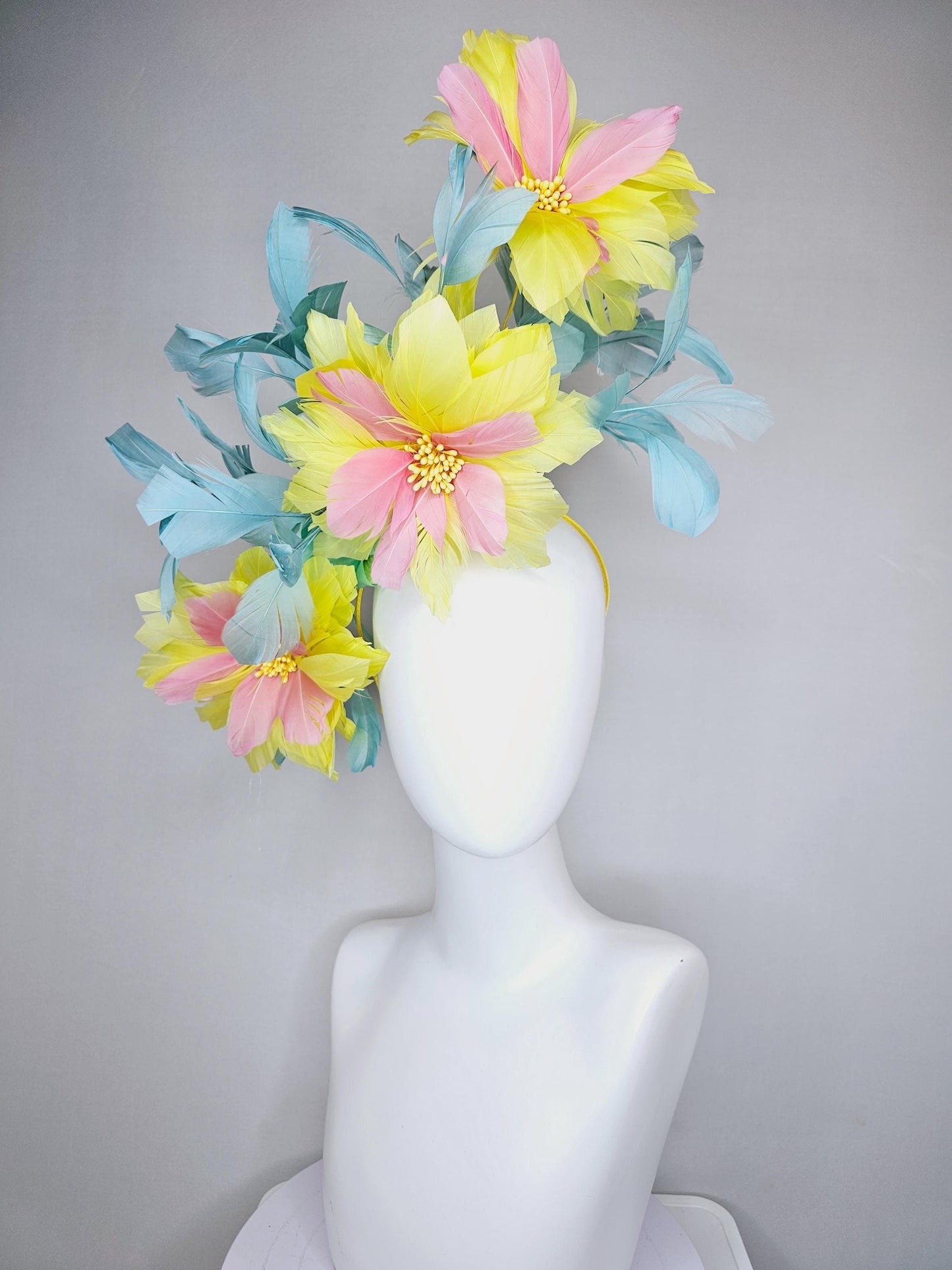 kentucky derby hat fascinator with large yellow light blush pink feather flowers and light teal blue branching feathers