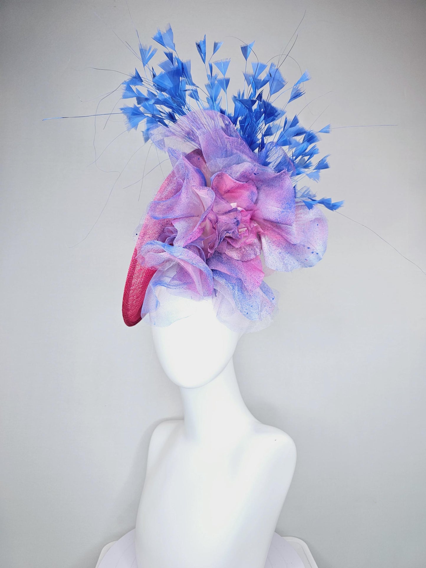 kentucky derby hat fascinator raspberry pink sinamay saucer with large pink blue tie dye organza satin rose, cobalt blue branching feathers