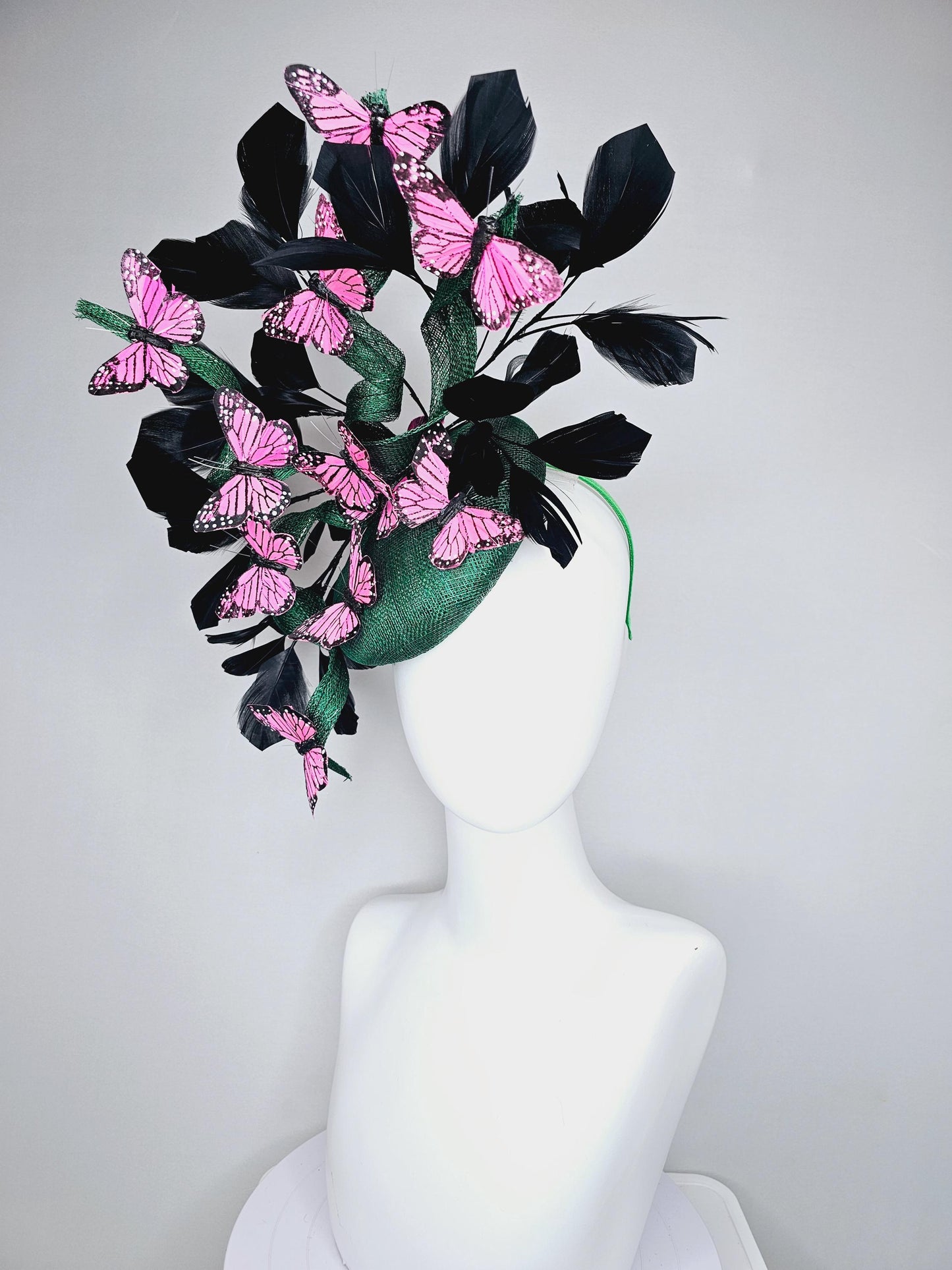 kentucky derby hat fascinator dark green sinamay with sinamay curls and black branching feathers with pink and black butterflies