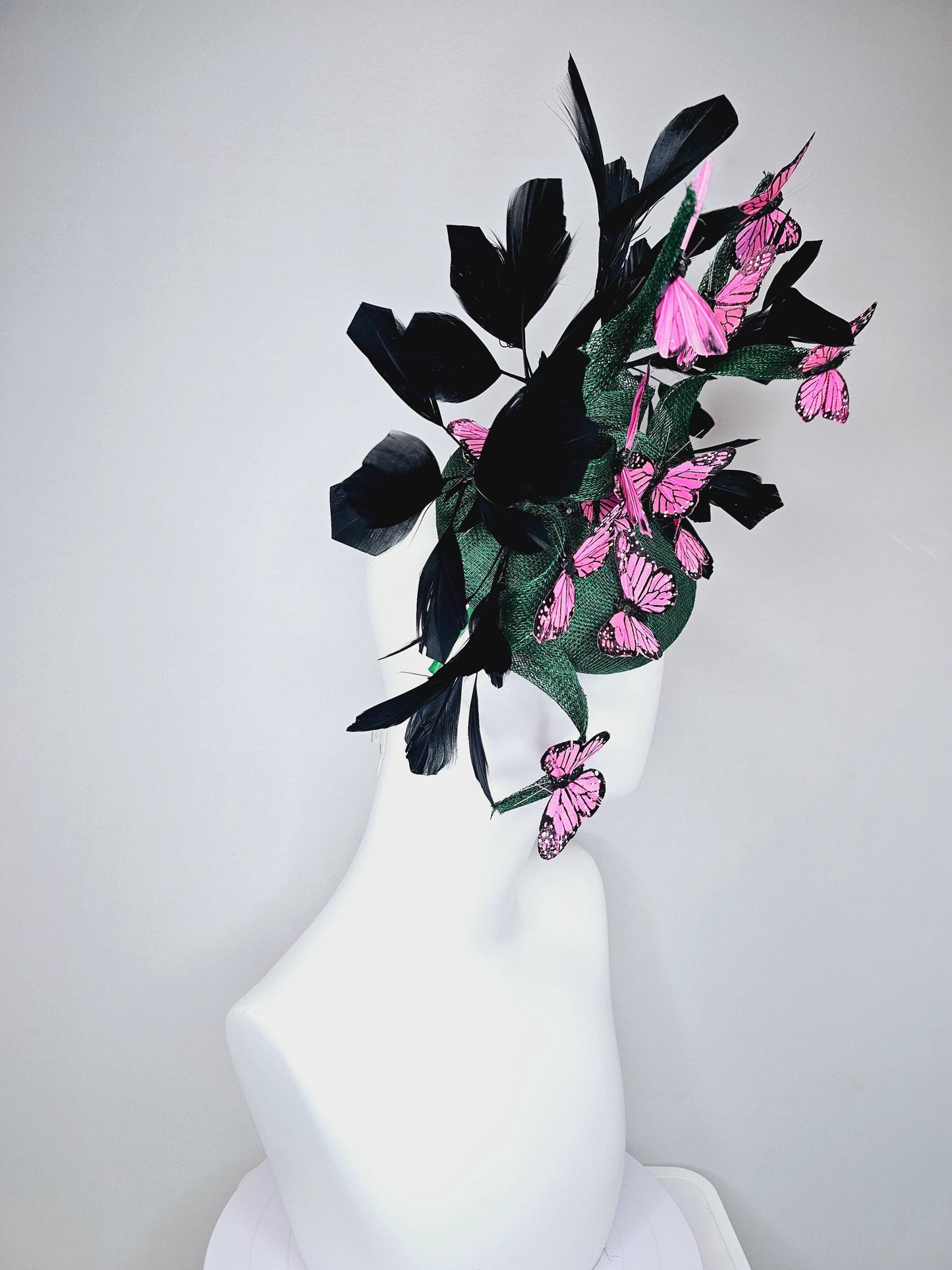 kentucky derby hat fascinator dark green sinamay with sinamay curls and black branching feathers with pink and black butterflies