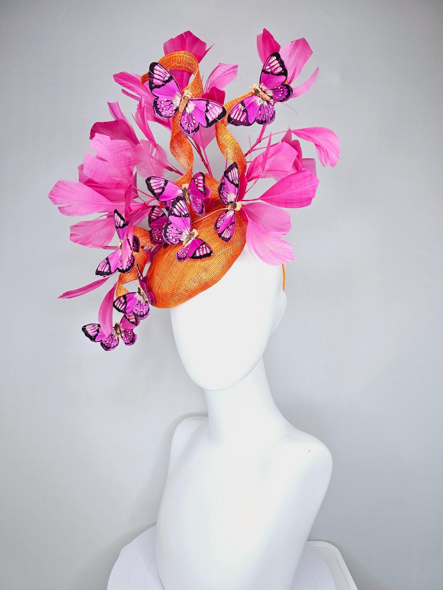 kentucky derby hat fascinator tangerine orange sinamay with sinamay curls and hot pink branching feathers with pink and black butterflies