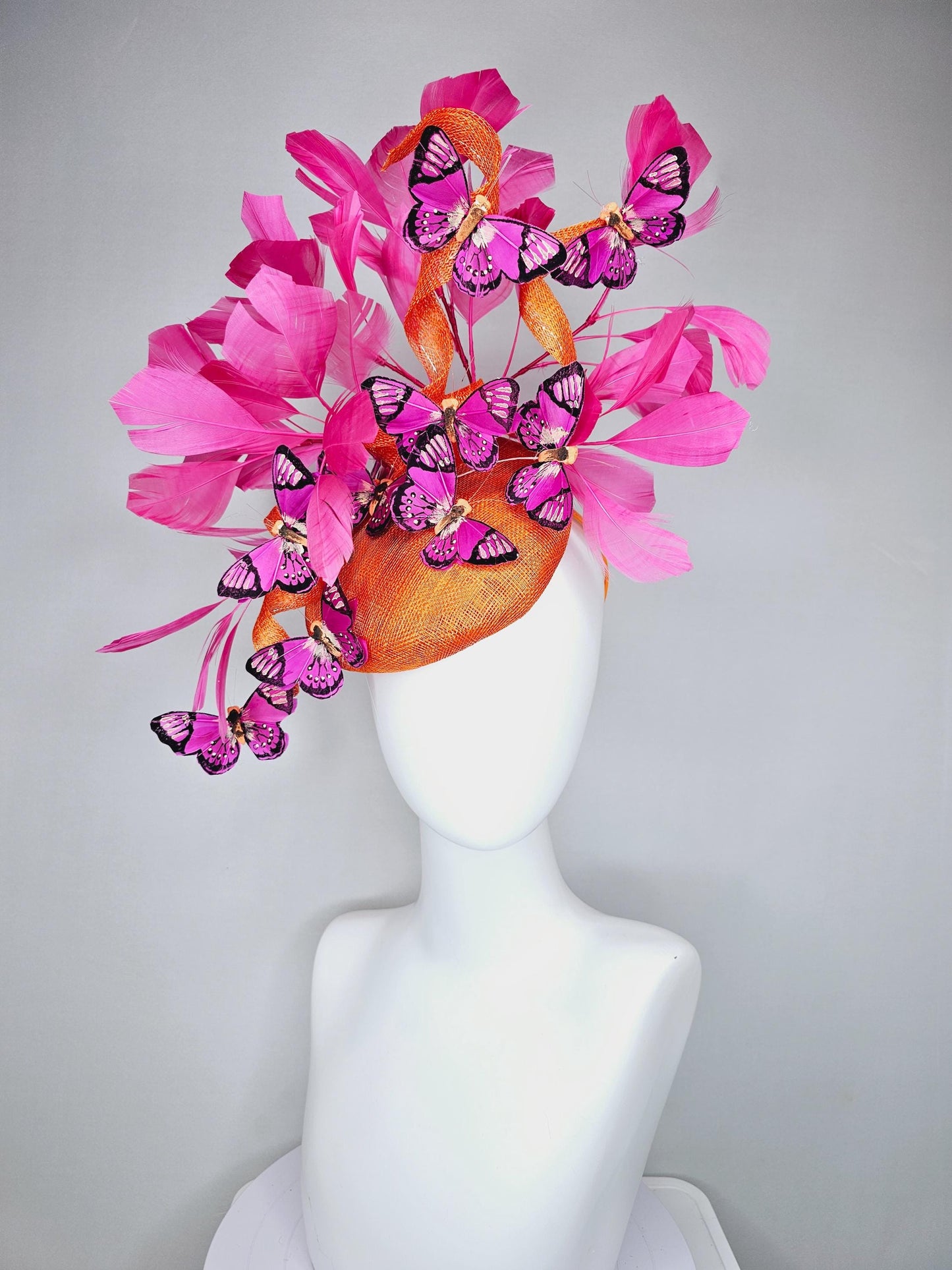 kentucky derby hat fascinator tangerine orange sinamay with sinamay curls and hot pink branching feathers with pink and black butterflies