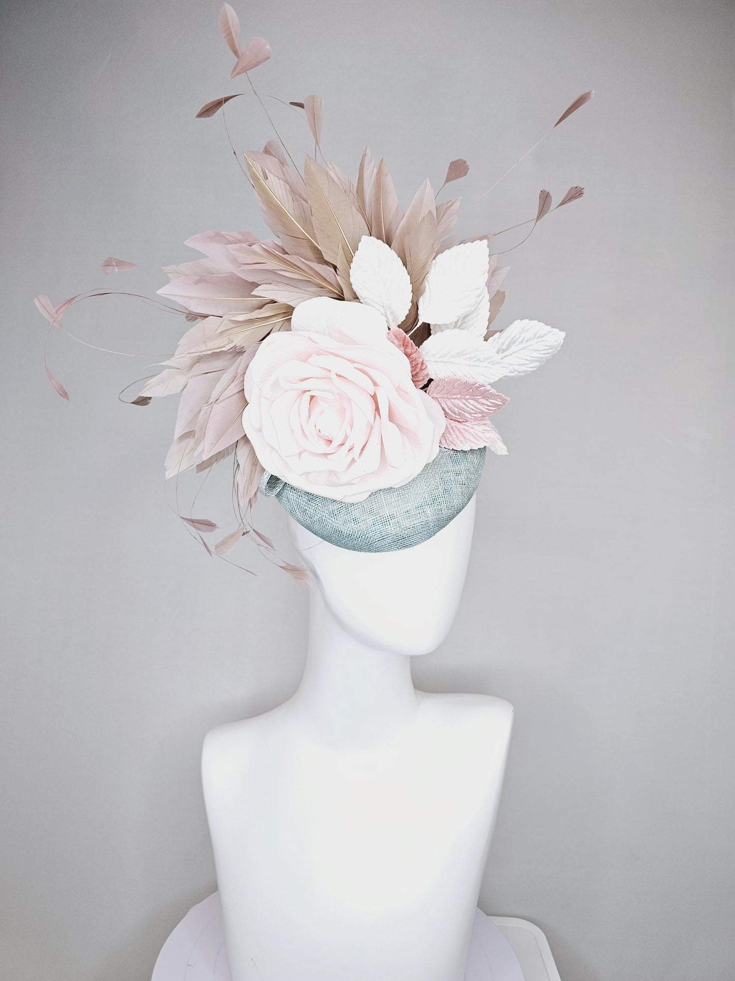 kentucky derby hat fascinator light blue sinamay with light pink satin rose flower, light pink leaves, light brown taupe branching feathers