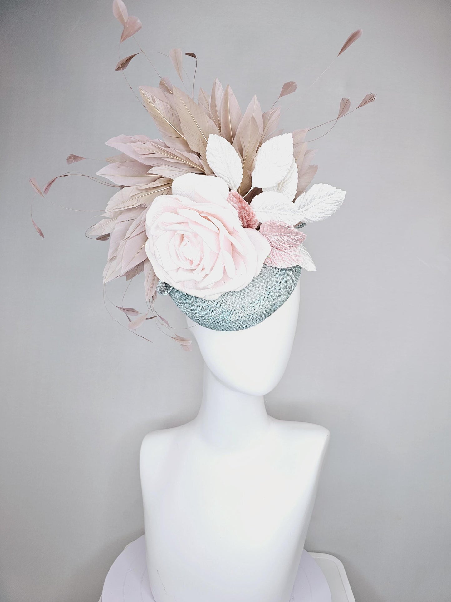 kentucky derby hat fascinator light blue sinamay with light pink satin rose flower, light pink leaves, light brown taupe branching feathers