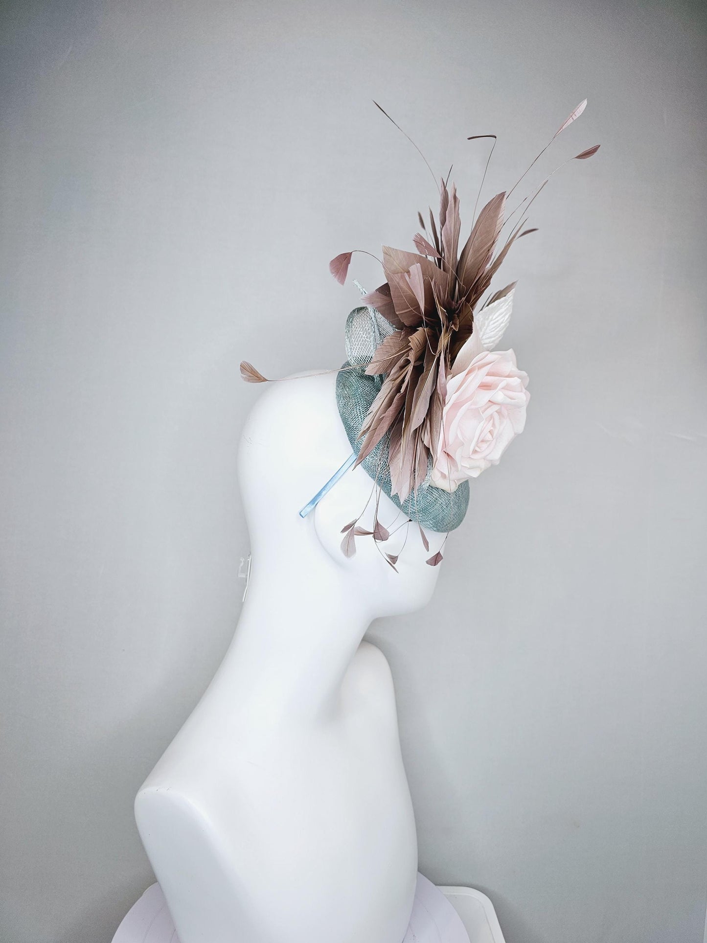 kentucky derby hat fascinator light blue sinamay with light pink satin rose flower, light pink leaves, light brown taupe branching feathers