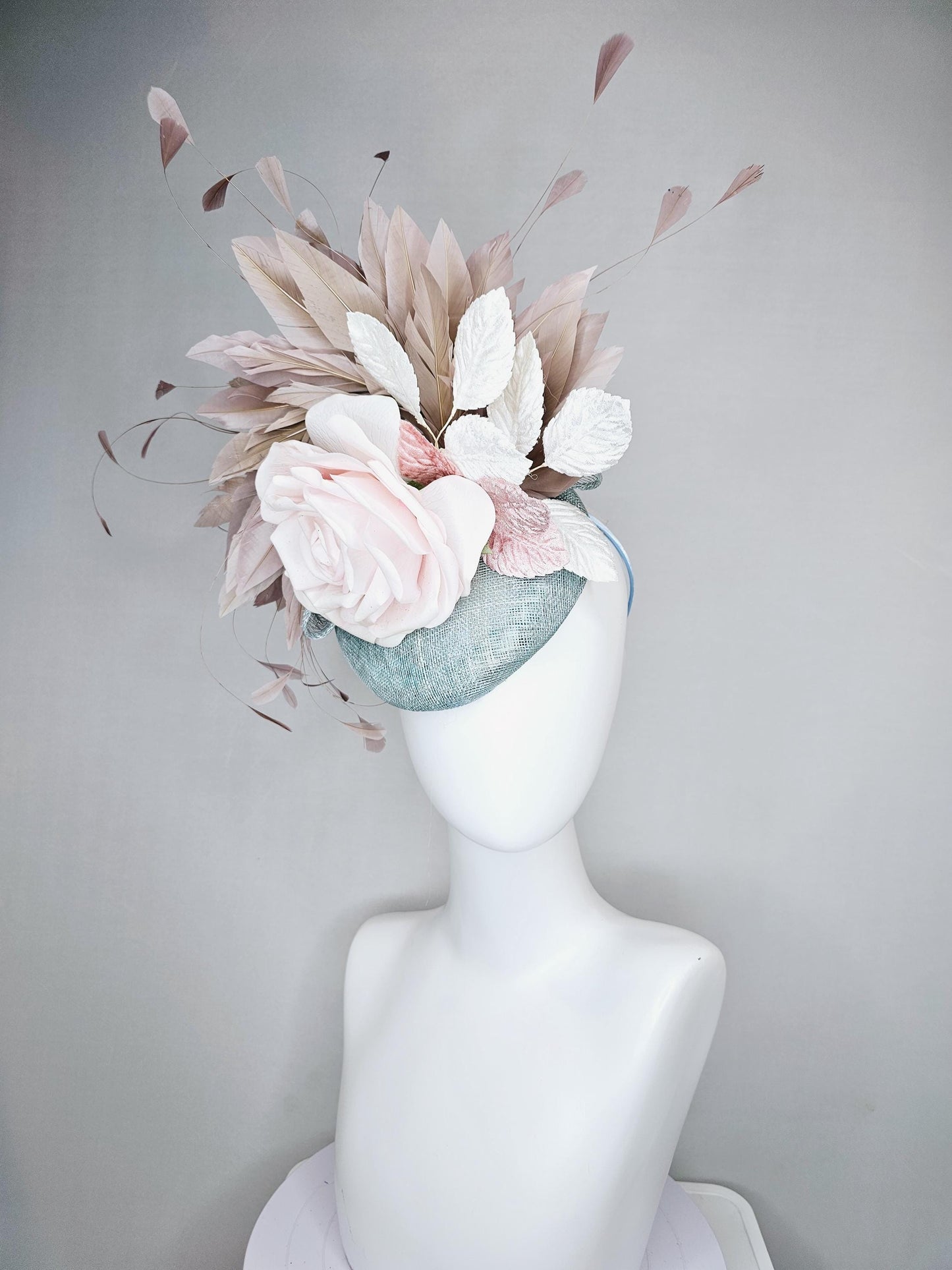 kentucky derby hat fascinator light blue sinamay with light pink satin rose flower, light pink leaves, light brown taupe branching feathers