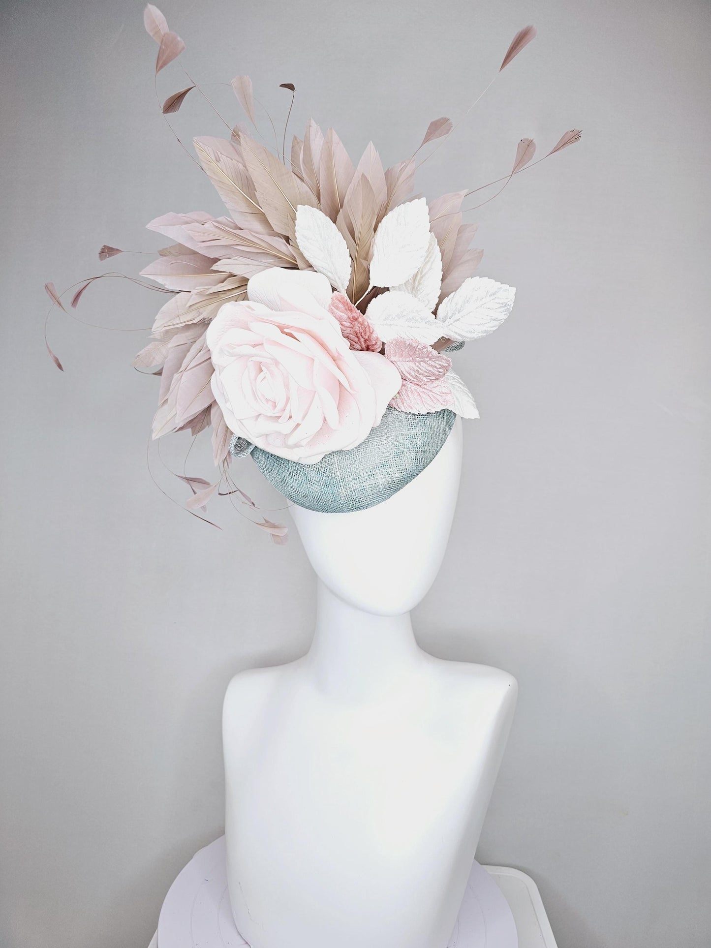 kentucky derby hat fascinator light blue sinamay with light pink satin rose flower, light pink leaves, light brown taupe branching feathers
