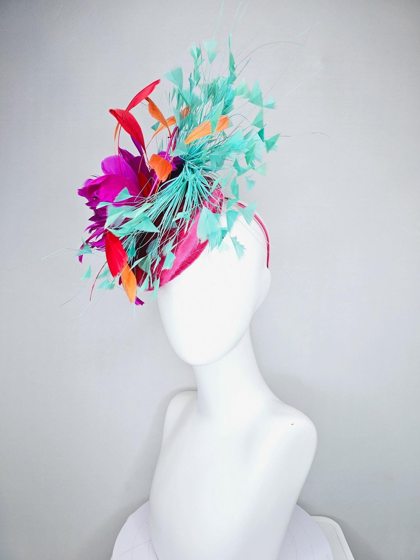 kentucky derby hat fascinator pink satin with netting and fluffy bright pink fuchsia, aqua blue green, red, orange coral branching feathers