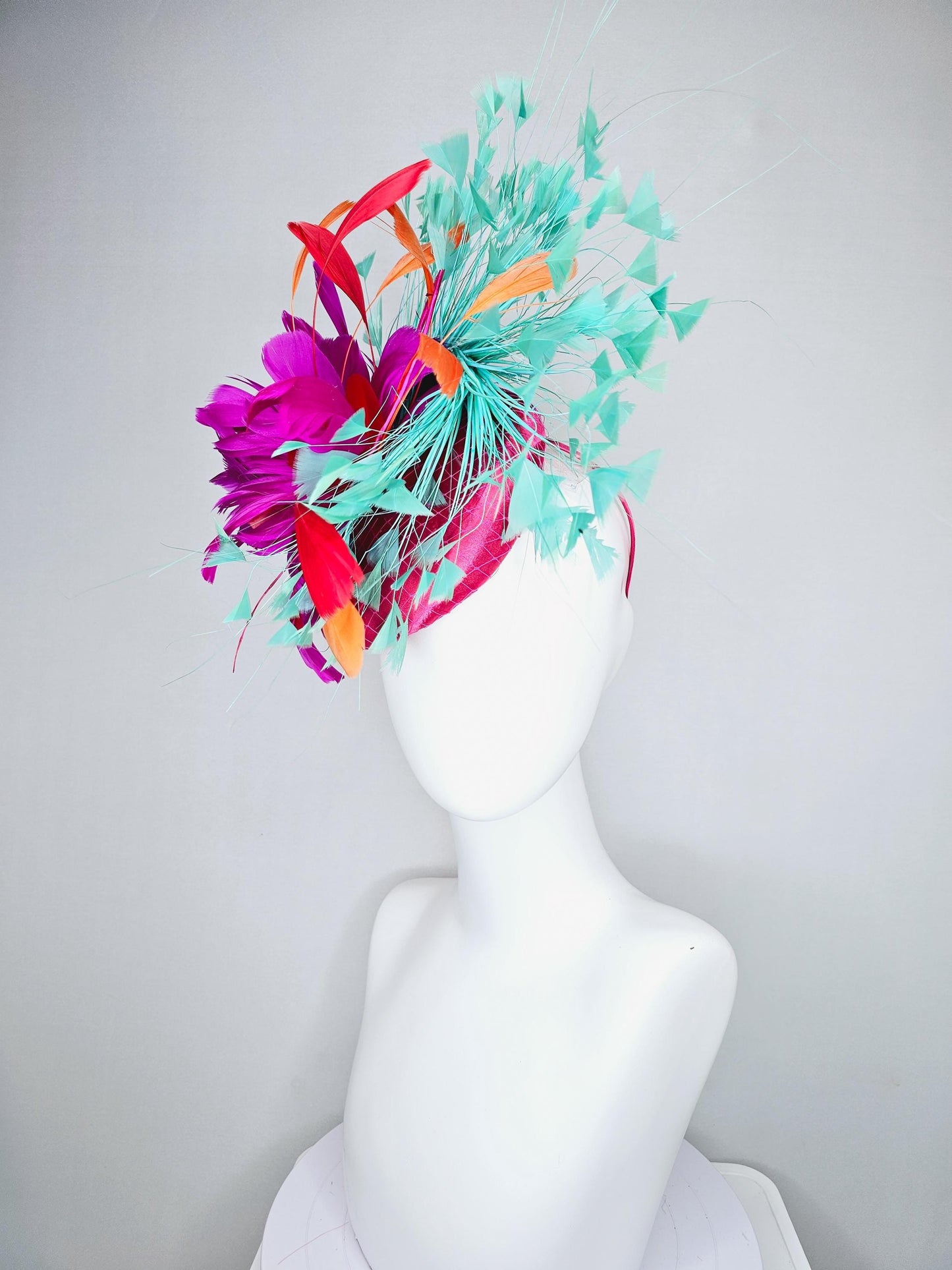 kentucky derby hat fascinator pink satin with netting and fluffy bright pink fuchsia, aqua blue green, red, orange coral branching feathers