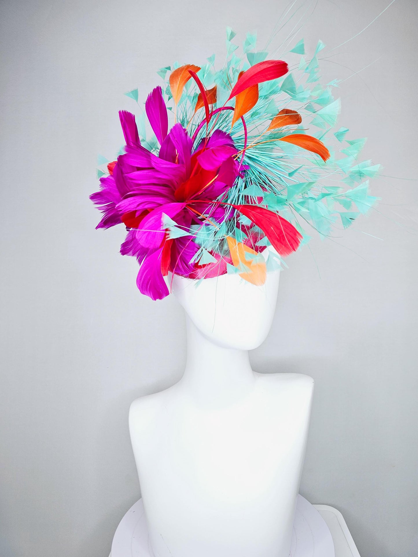 kentucky derby hat fascinator pink satin with netting and fluffy bright pink fuchsia, aqua blue green, red, orange coral branching feathers