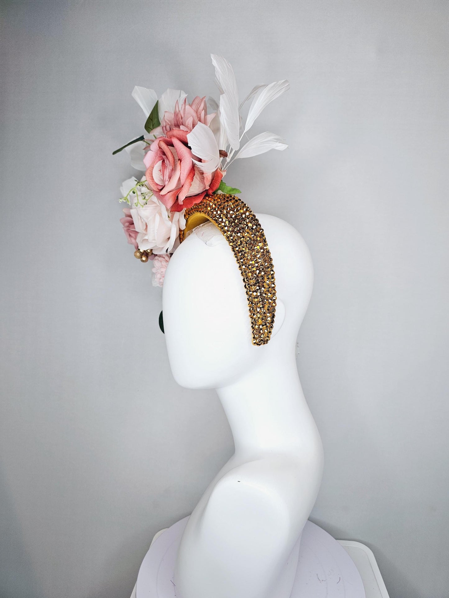 kentucky derby hat fascinator gold crystal headband, light pink dusty pink satin flowers, green leaves, ivory white feathers