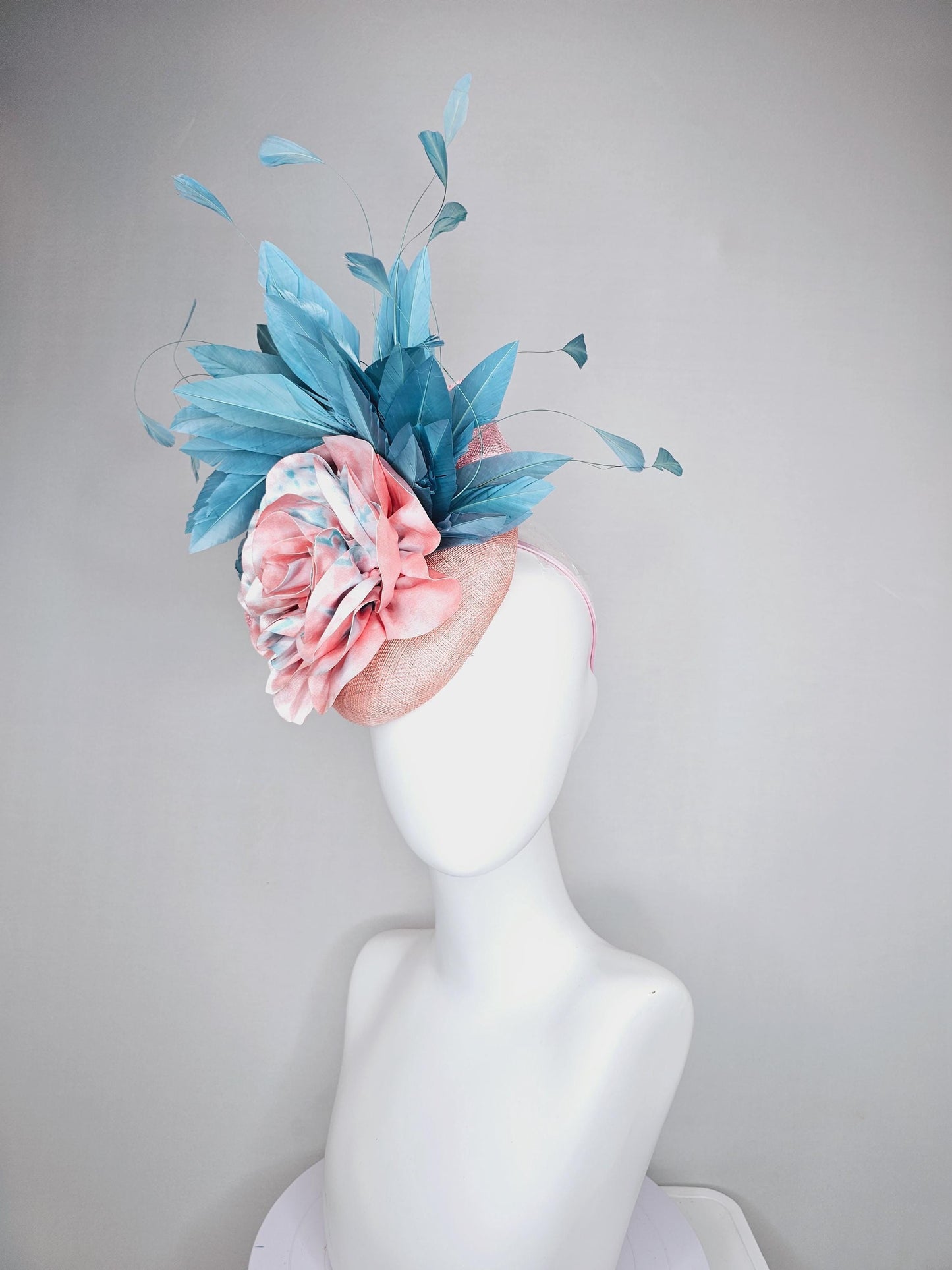 kentucky derby hat fascinator light baby pink sinamay with bright blue branching feathers and large pink and blue tie dye rose flower