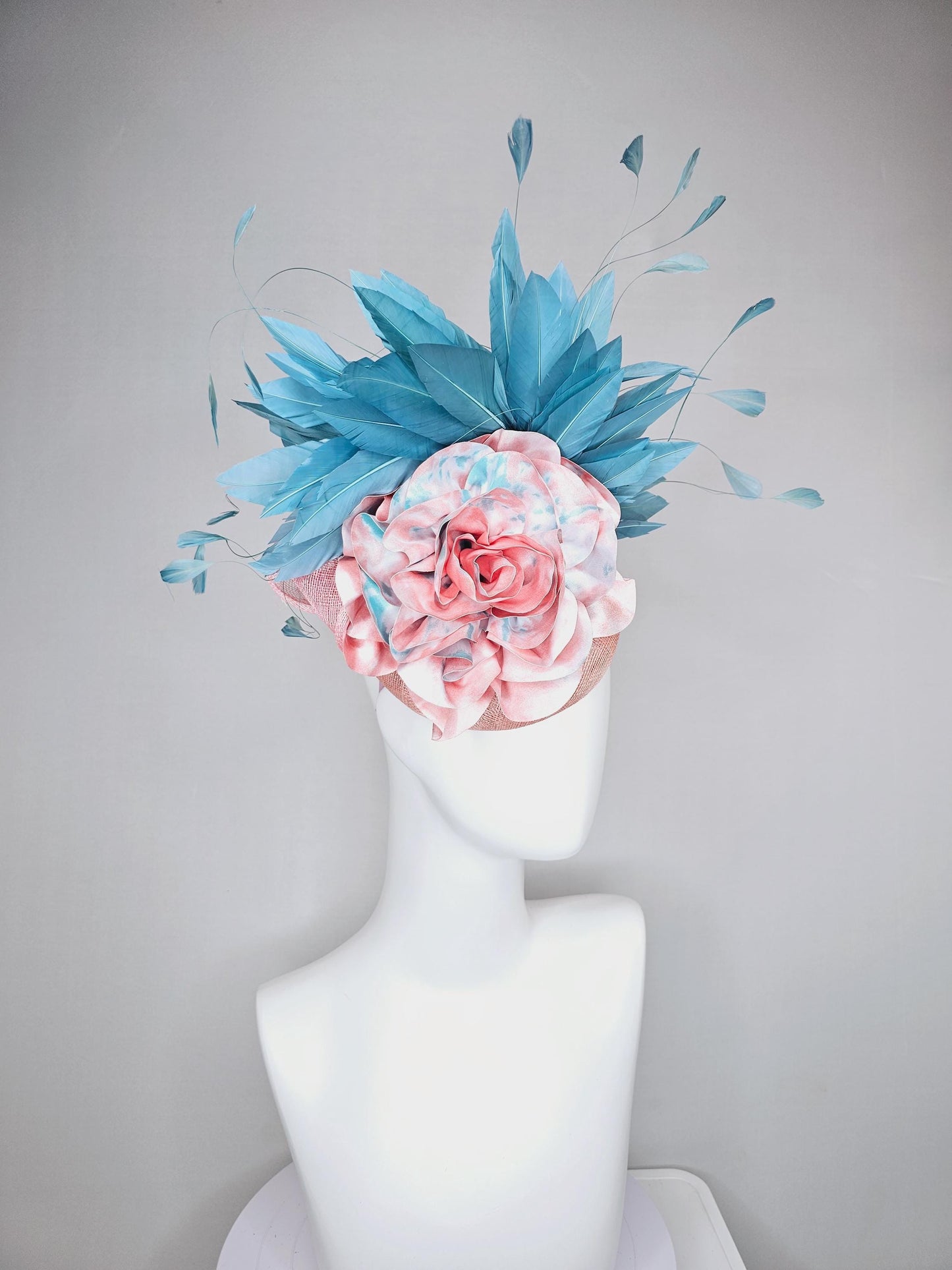 kentucky derby hat fascinator light baby pink sinamay with bright blue branching feathers and large pink and blue tie dye rose flower