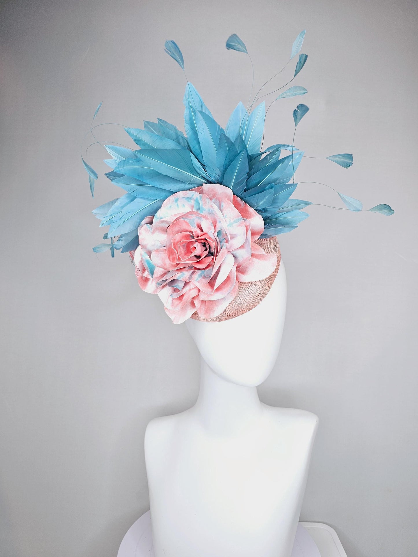 kentucky derby hat fascinator light baby pink sinamay with bright blue branching feathers and large pink and blue tie dye rose flower