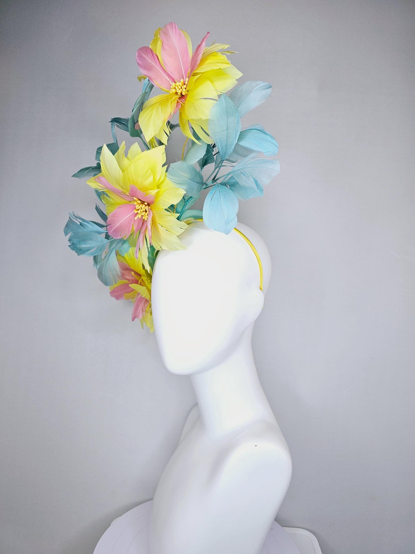 kentucky derby hat fascinator with large yellow light blush pink feather flowers and light teal blue branching feathers