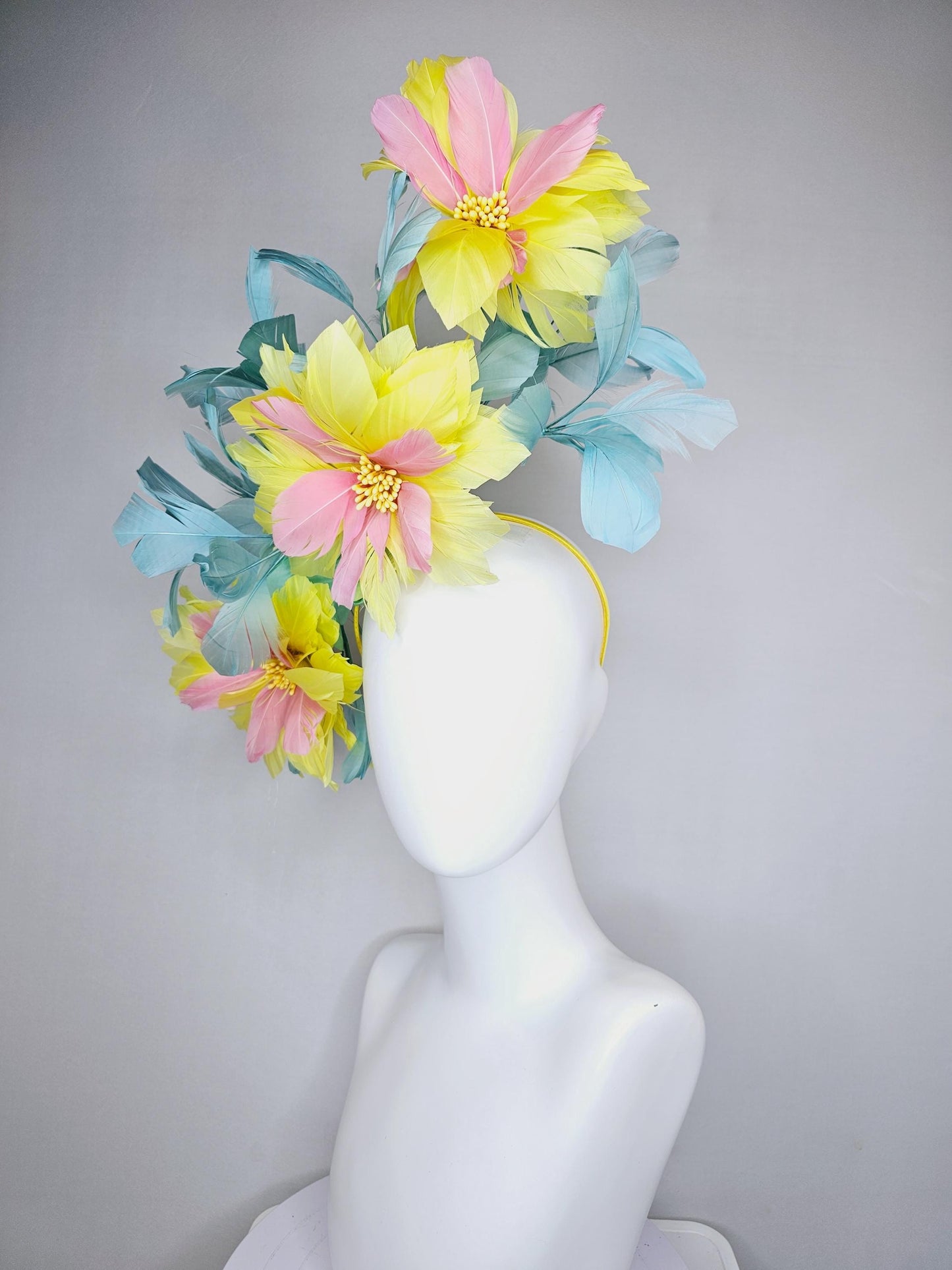 kentucky derby hat fascinator with large yellow light blush pink feather flowers and light teal blue branching feathers