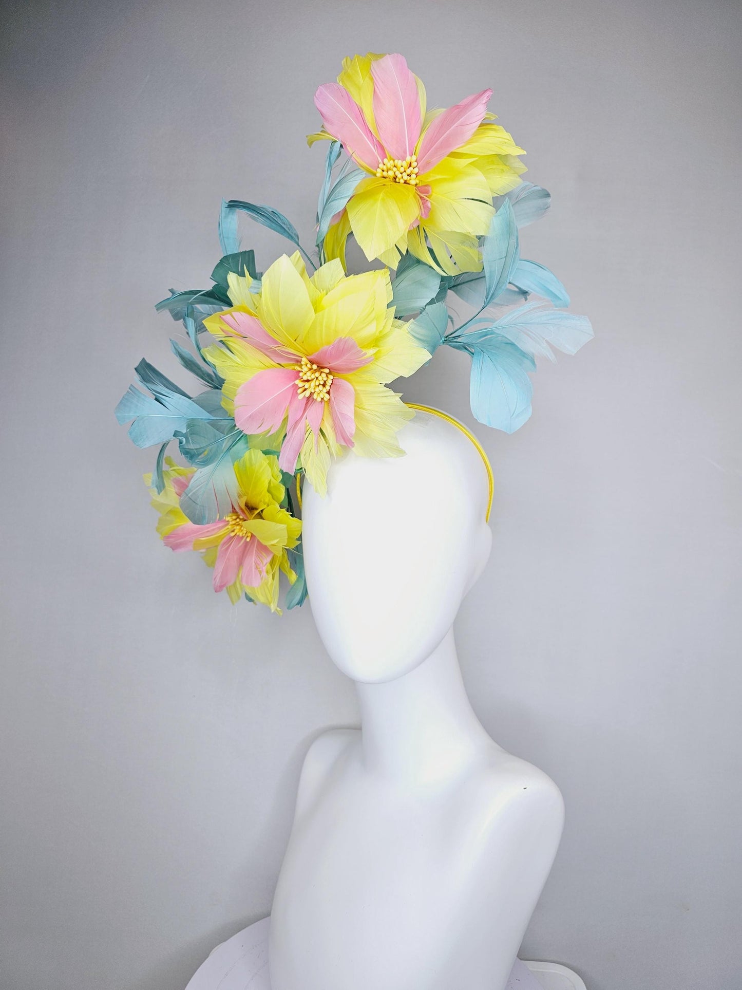 kentucky derby hat fascinator with large yellow light blush pink feather flowers and light teal blue branching feathers