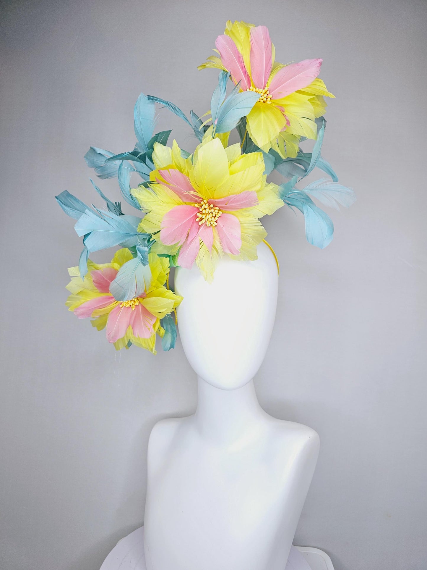 kentucky derby hat fascinator with large yellow light blush pink feather flowers and light teal blue branching feathers