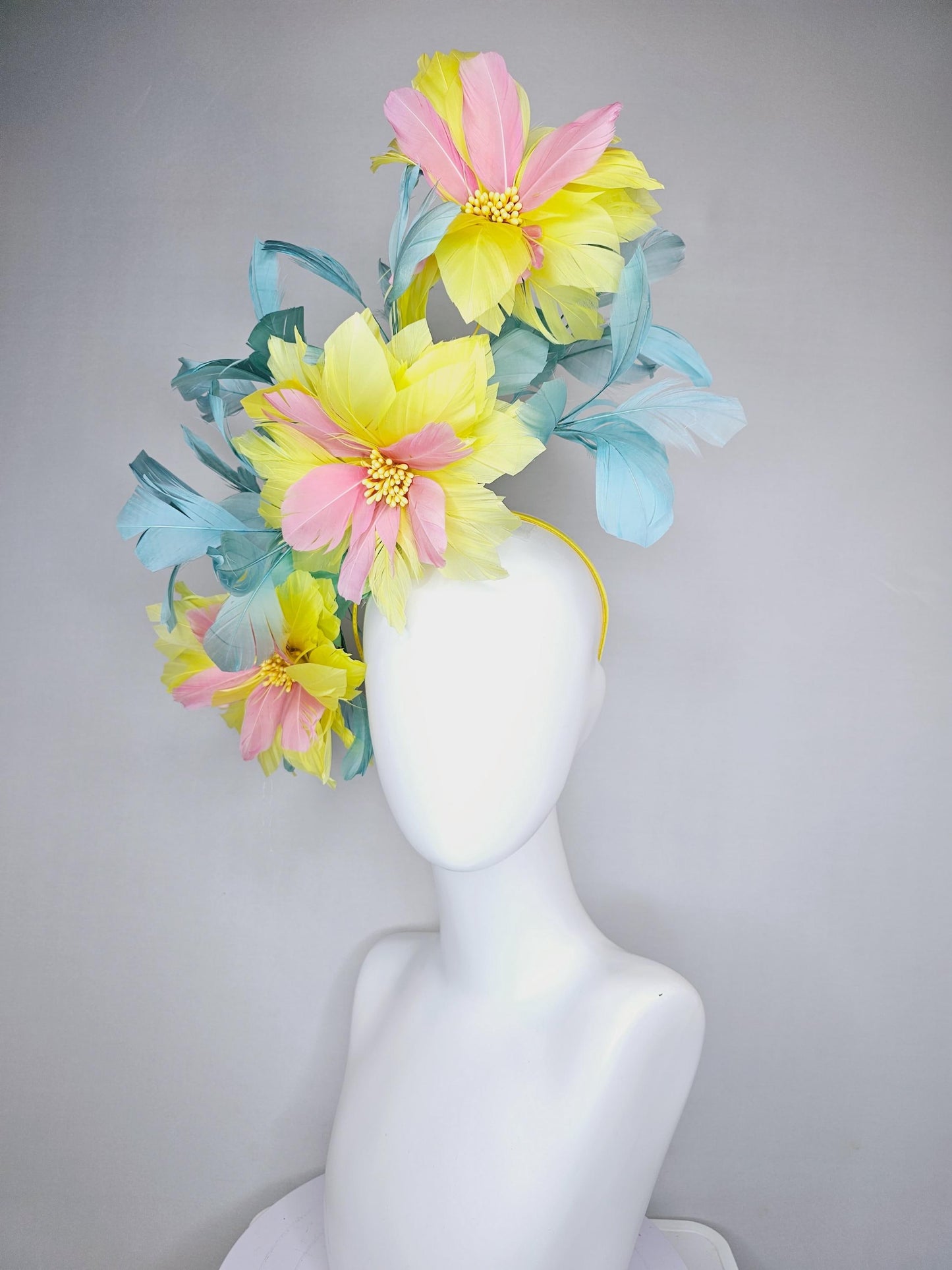 kentucky derby hat fascinator with large yellow light blush pink feather flowers and light teal blue branching feathers
