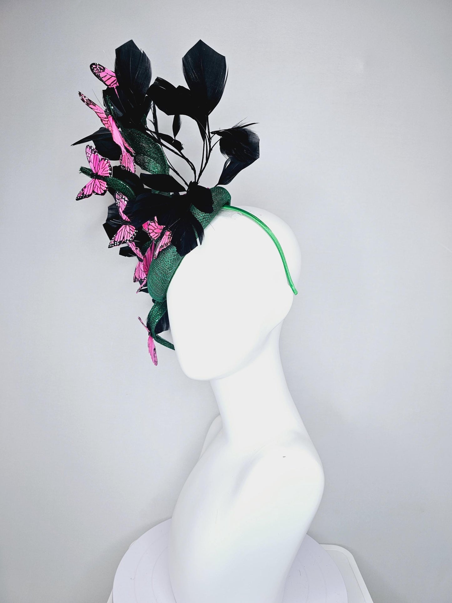 kentucky derby hat fascinator dark green sinamay with sinamay curls and black branching feathers with pink and black butterflies