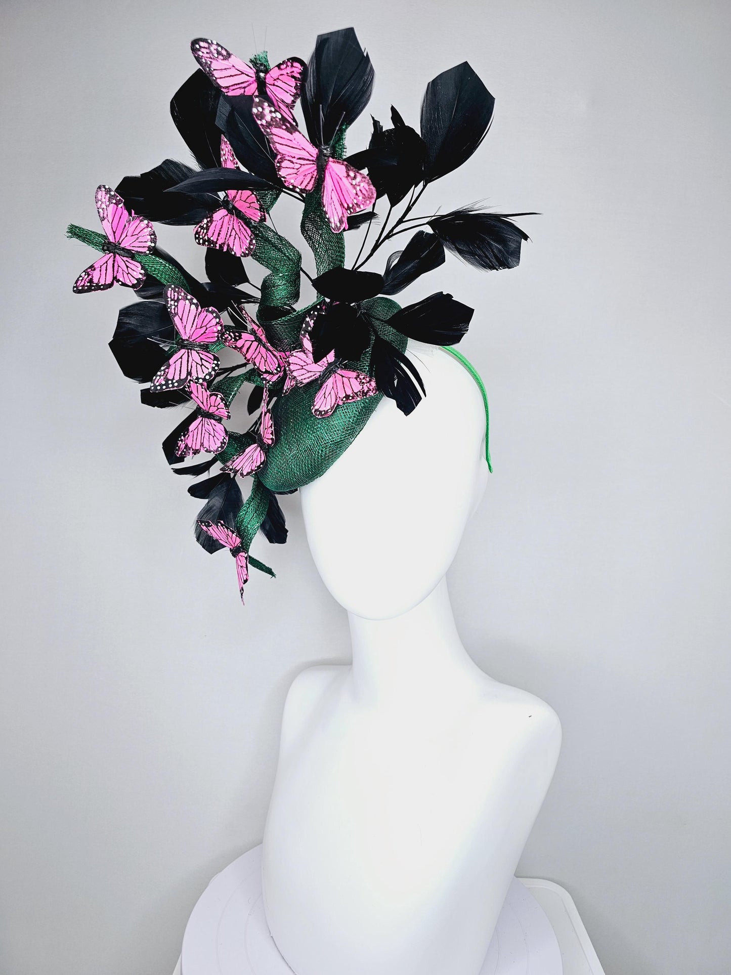 kentucky derby hat fascinator dark green sinamay with sinamay curls and black branching feathers with pink and black butterflies