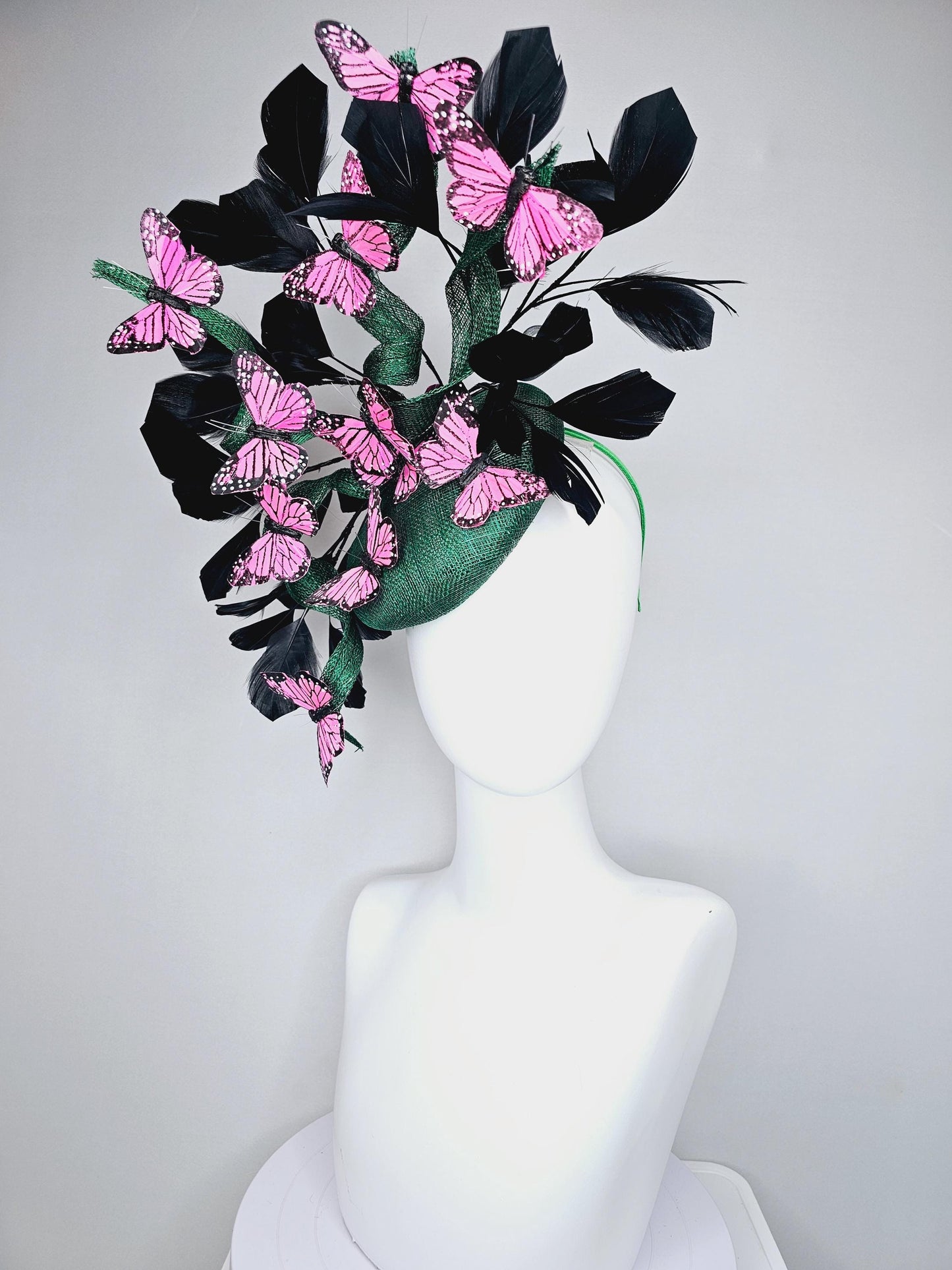 kentucky derby hat fascinator dark green sinamay with sinamay curls and black branching feathers with pink and black butterflies