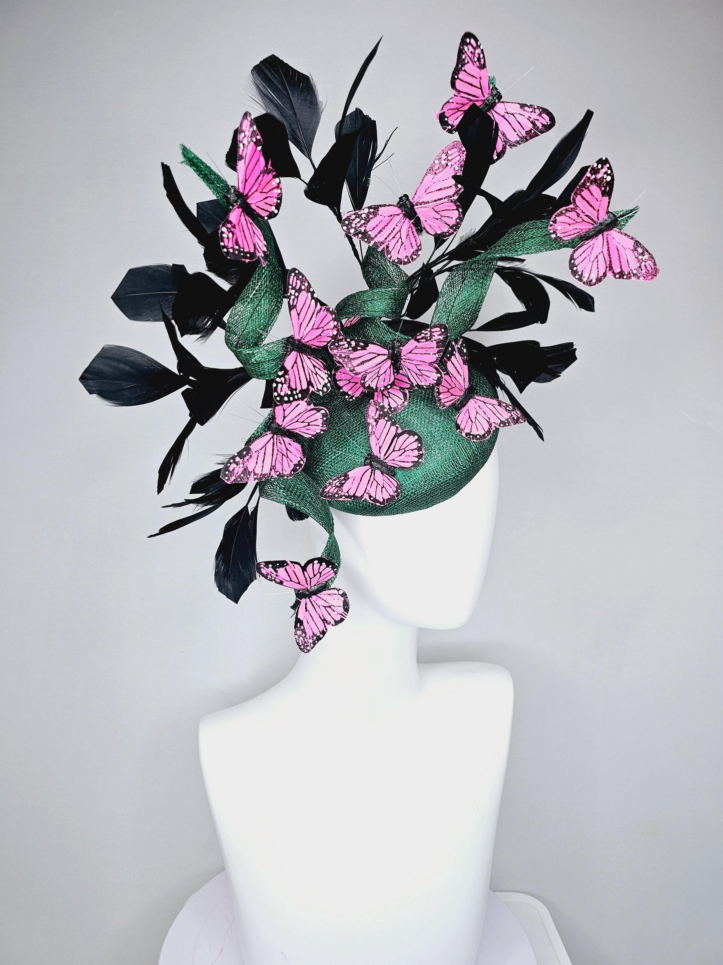kentucky derby hat fascinator dark green sinamay with sinamay curls and black branching feathers with pink and black butterflies