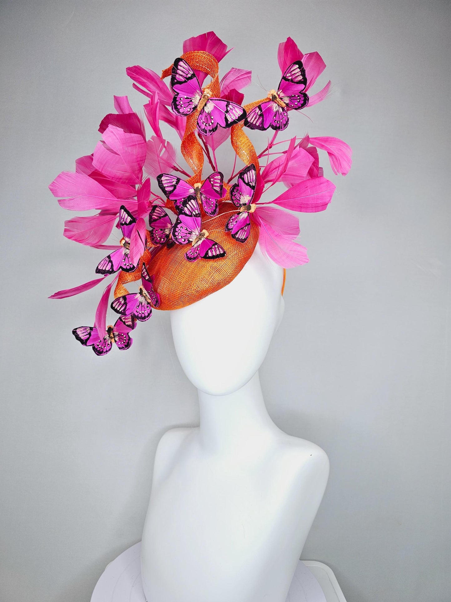 kentucky derby hat fascinator tangerine orange sinamay with sinamay curls and hot pink branching feathers with pink and black butterflies