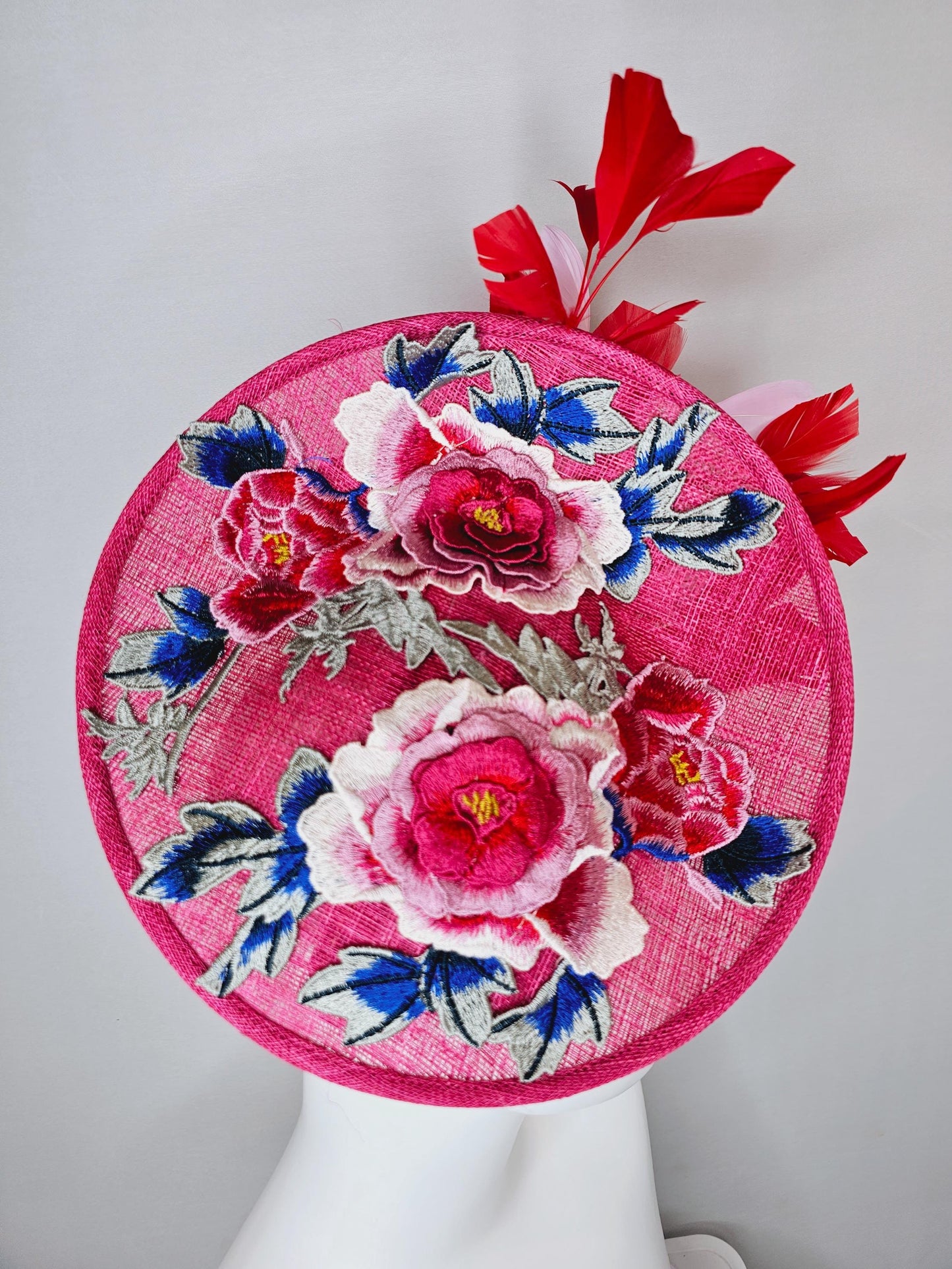 kentucky derby hat fascinator raspberry pink sinamay saucer with red pink blue green floral embroidered, scarlet red and light pink feathers
