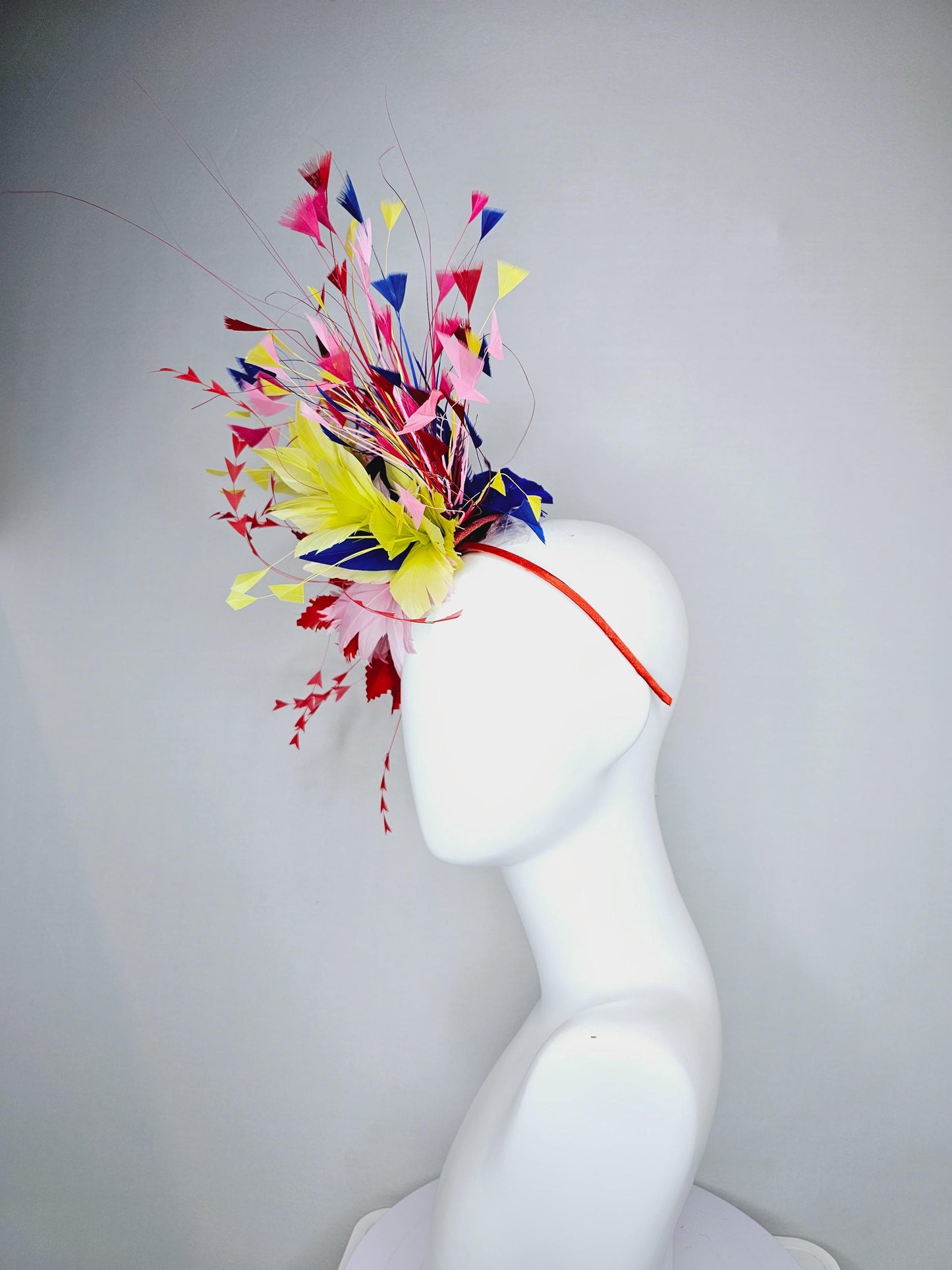 kentucky derby hat fascinator light pink and red zigzag feather flowers with colorful light pink, yellow, cobalt blue,red branching feathers
