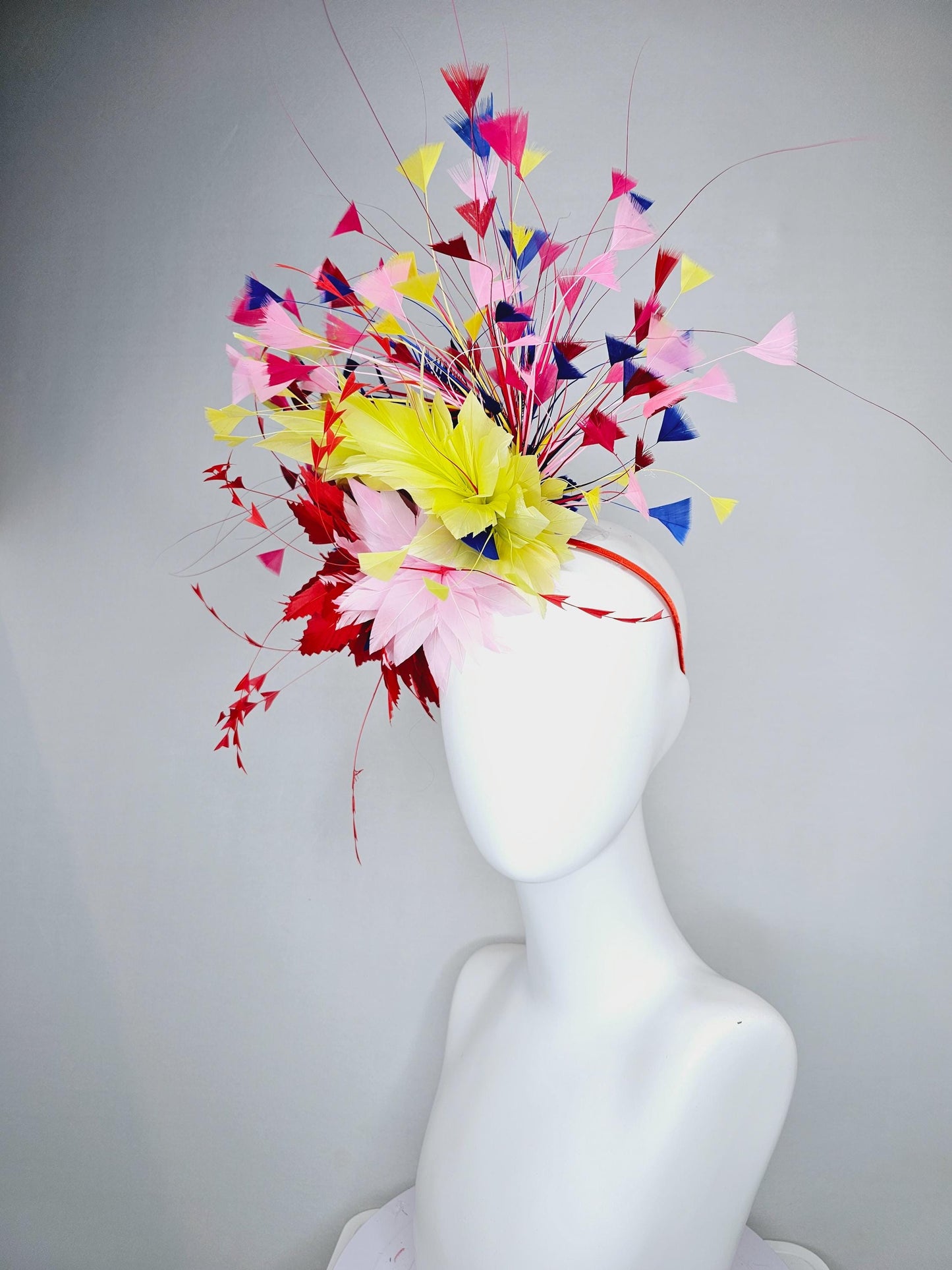 kentucky derby hat fascinator light pink and red zigzag feather flowers with colorful light pink, yellow, cobalt blue,red branching feathers
